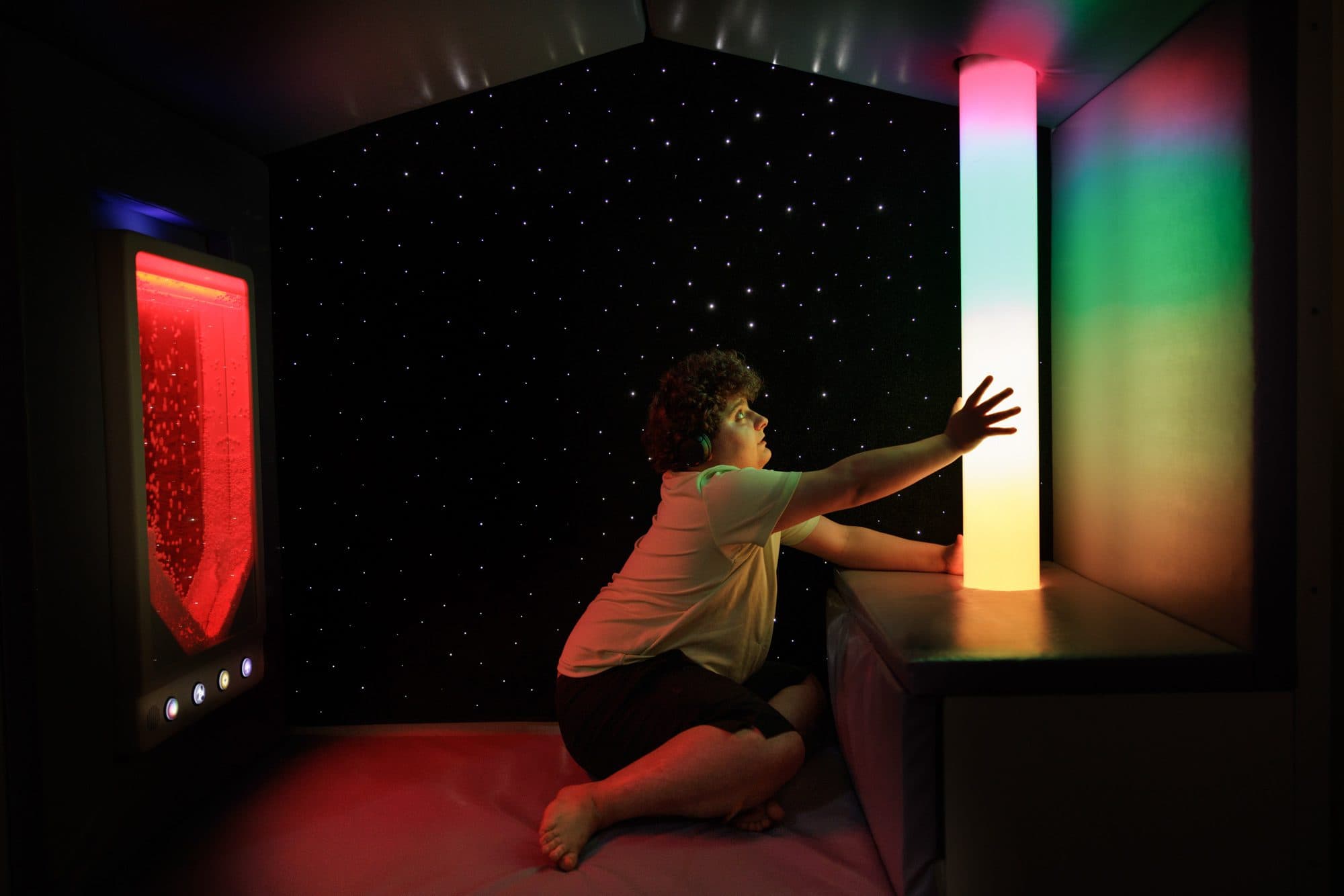 Student interacting with the sensory lights in the sensory room.