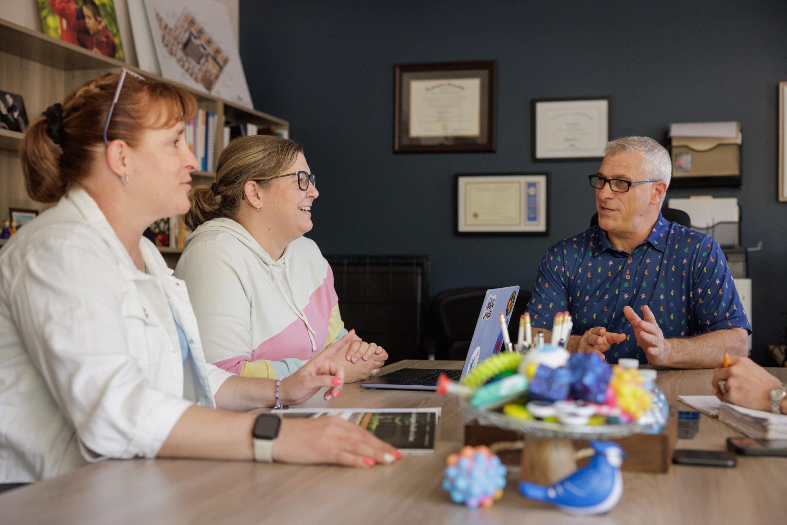 Staff members meeting around a table