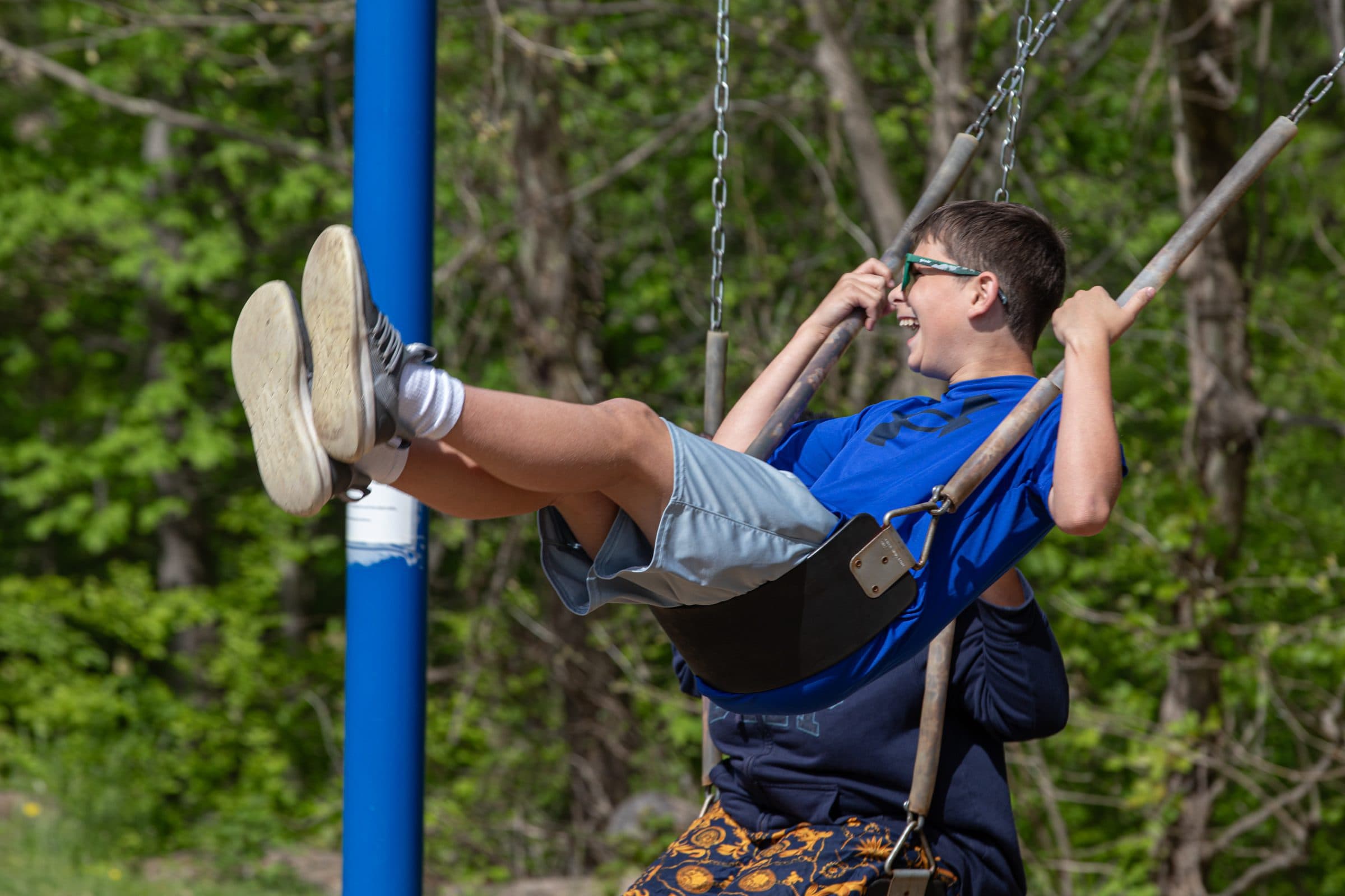 Student swinging outdoors during recess