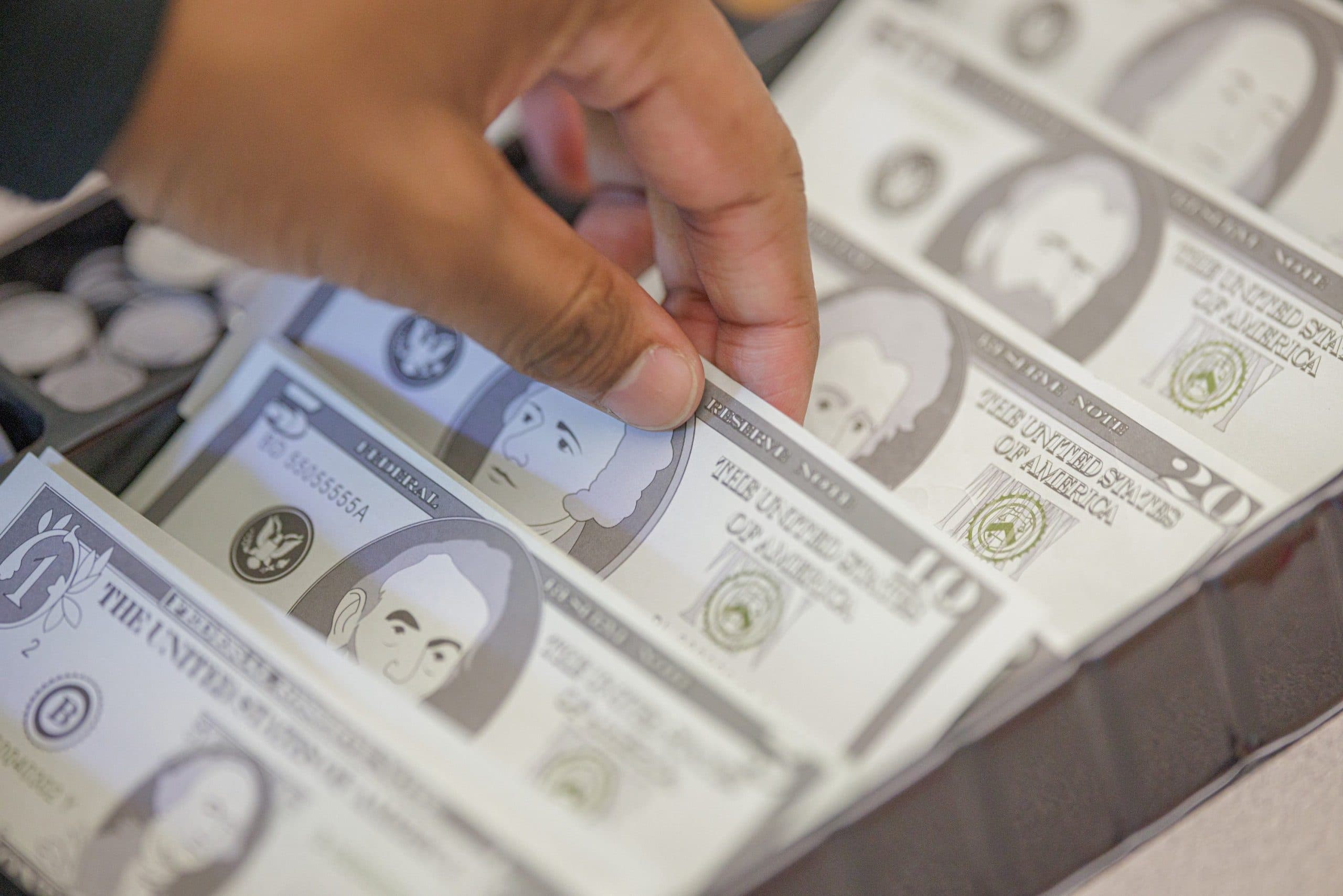 Student counting money as part of a life-skills activity