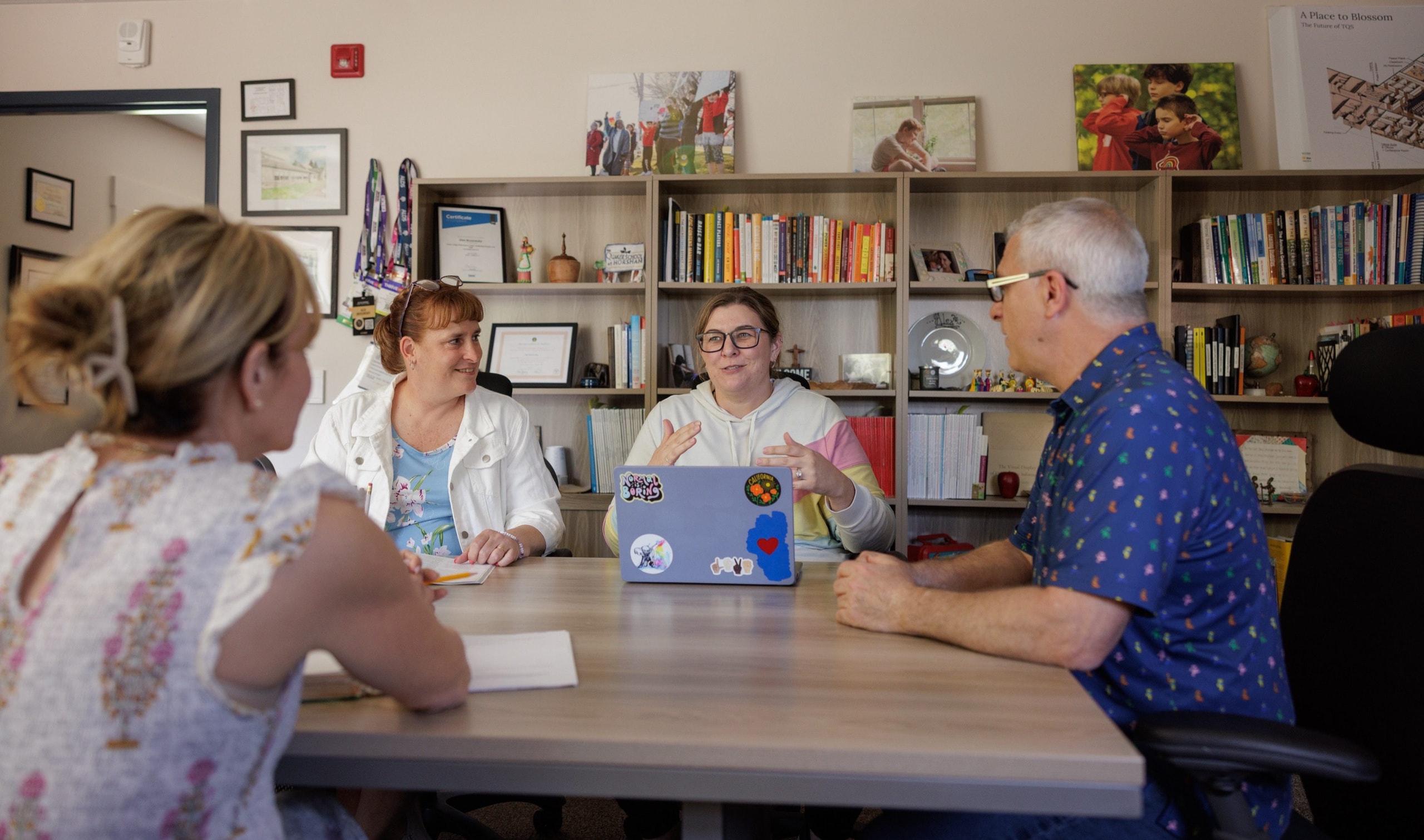 Staff members meeting around a table