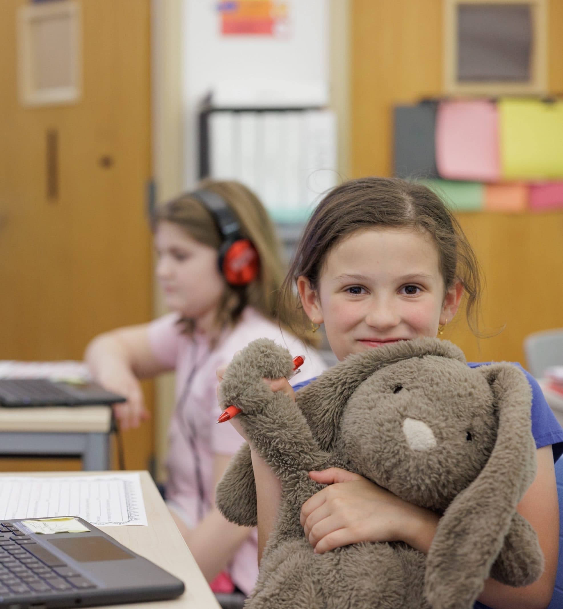 Student holding a toy bunny