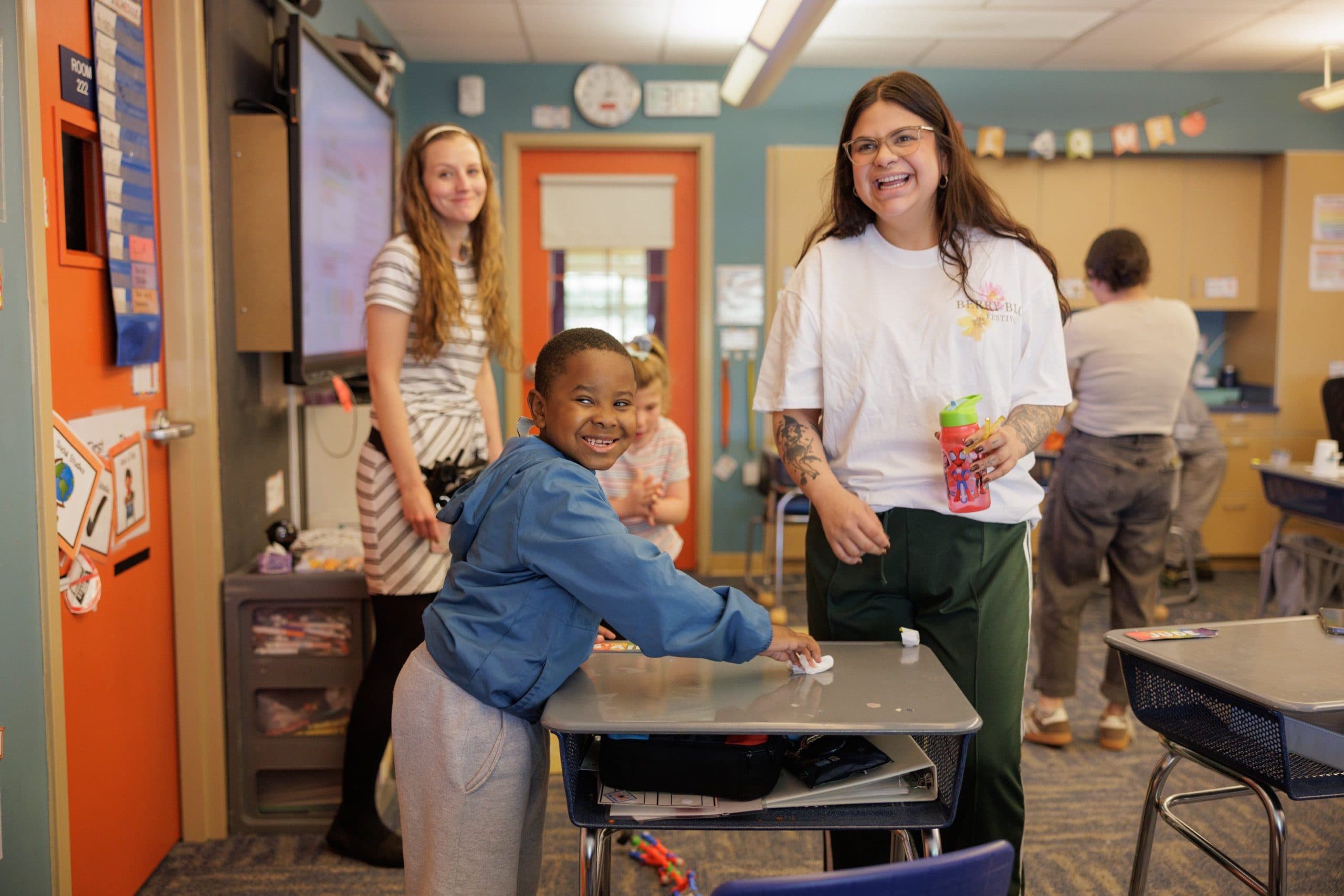 Teacher laughing with students