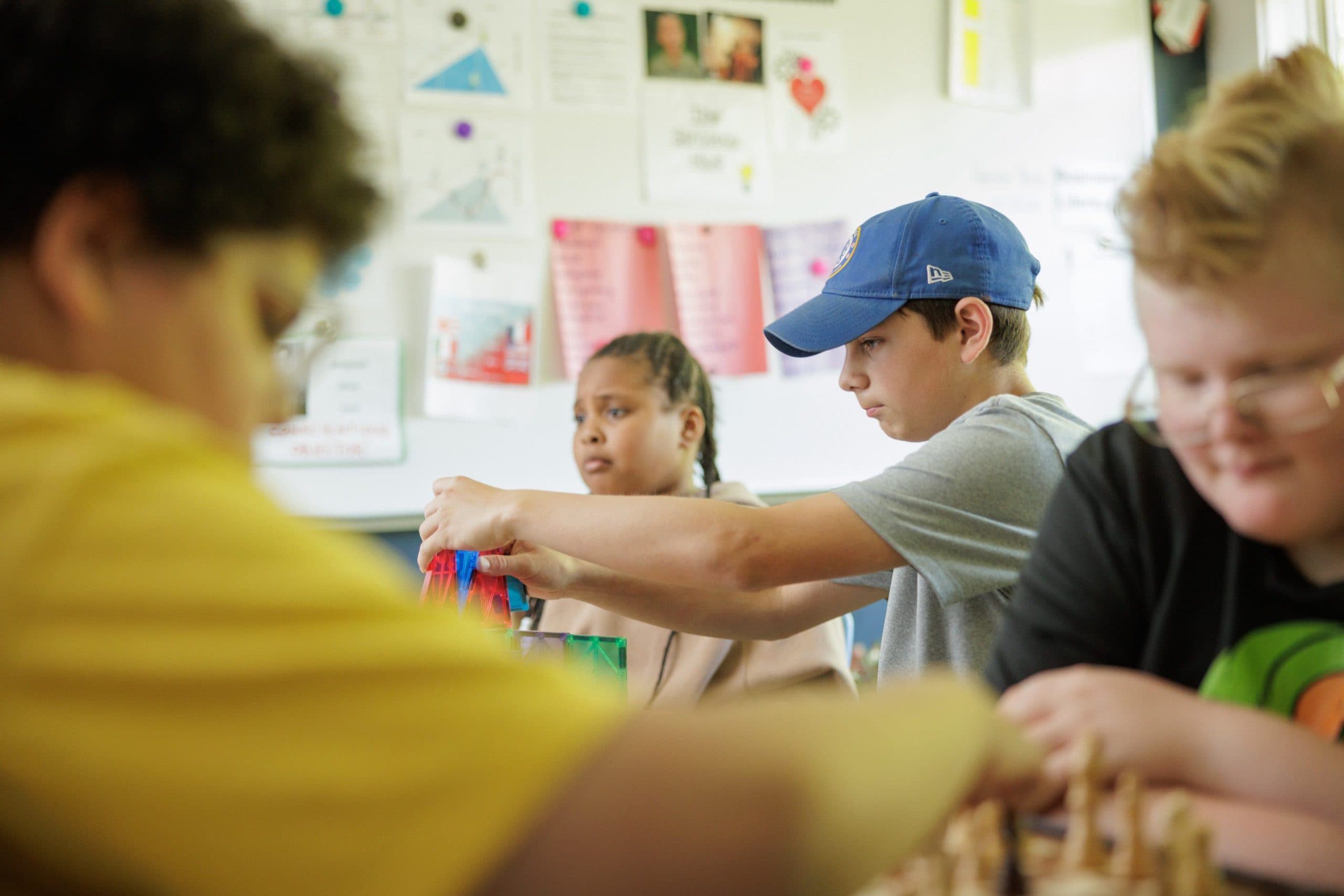 Student playing with magnetic tiles