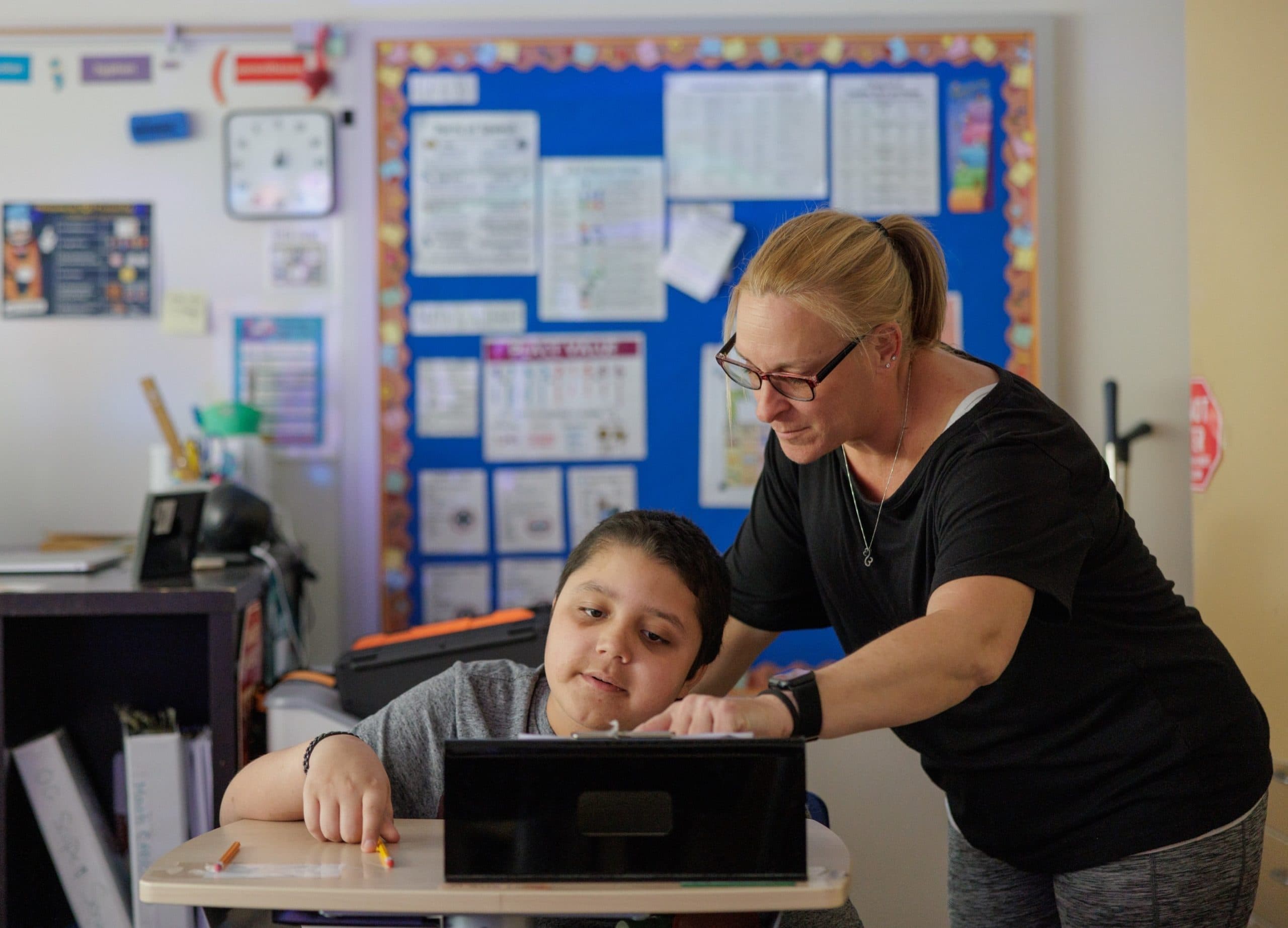 Teacher helping a student in a classroom