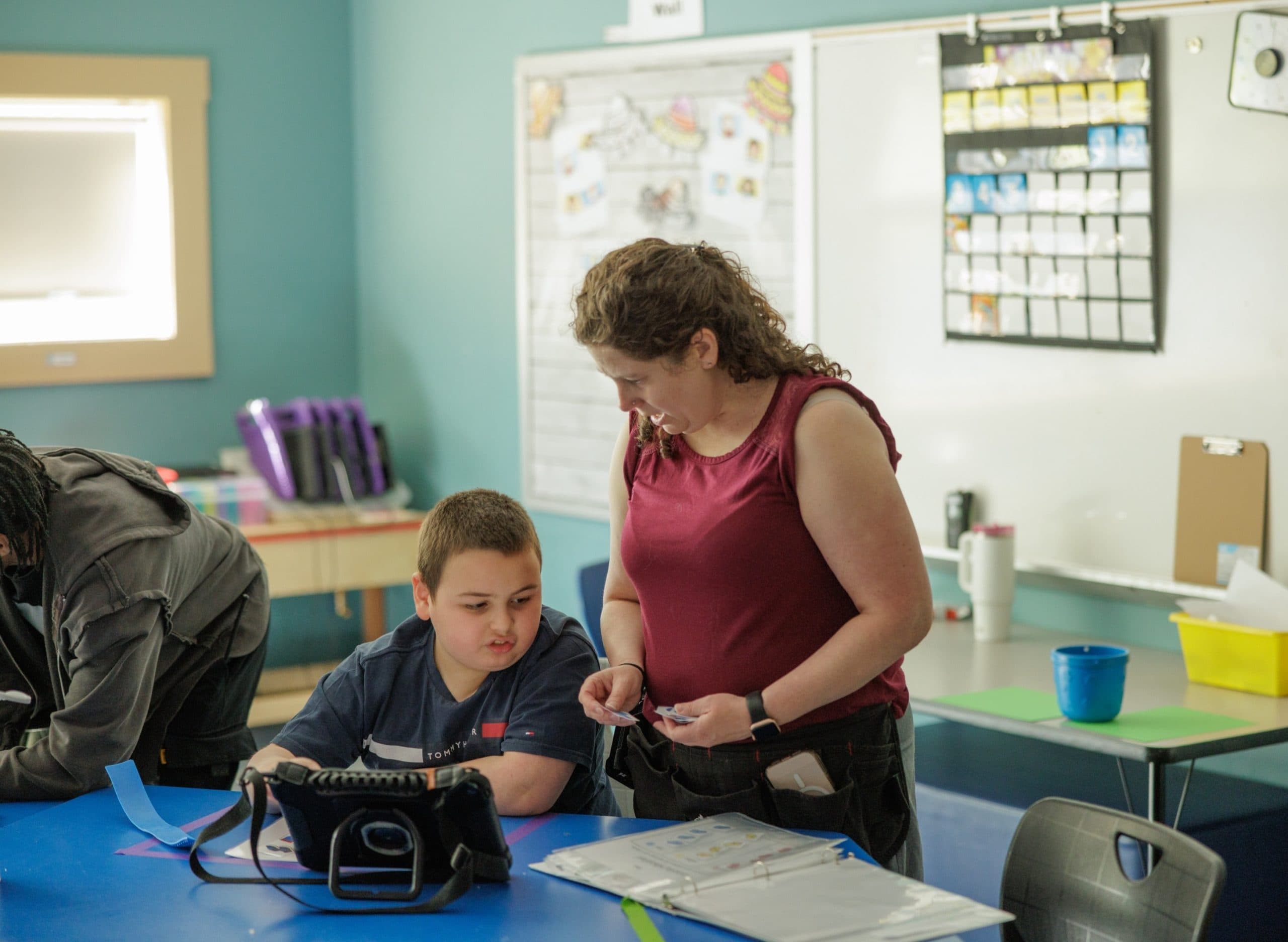 Teacher helping a student in a classroom