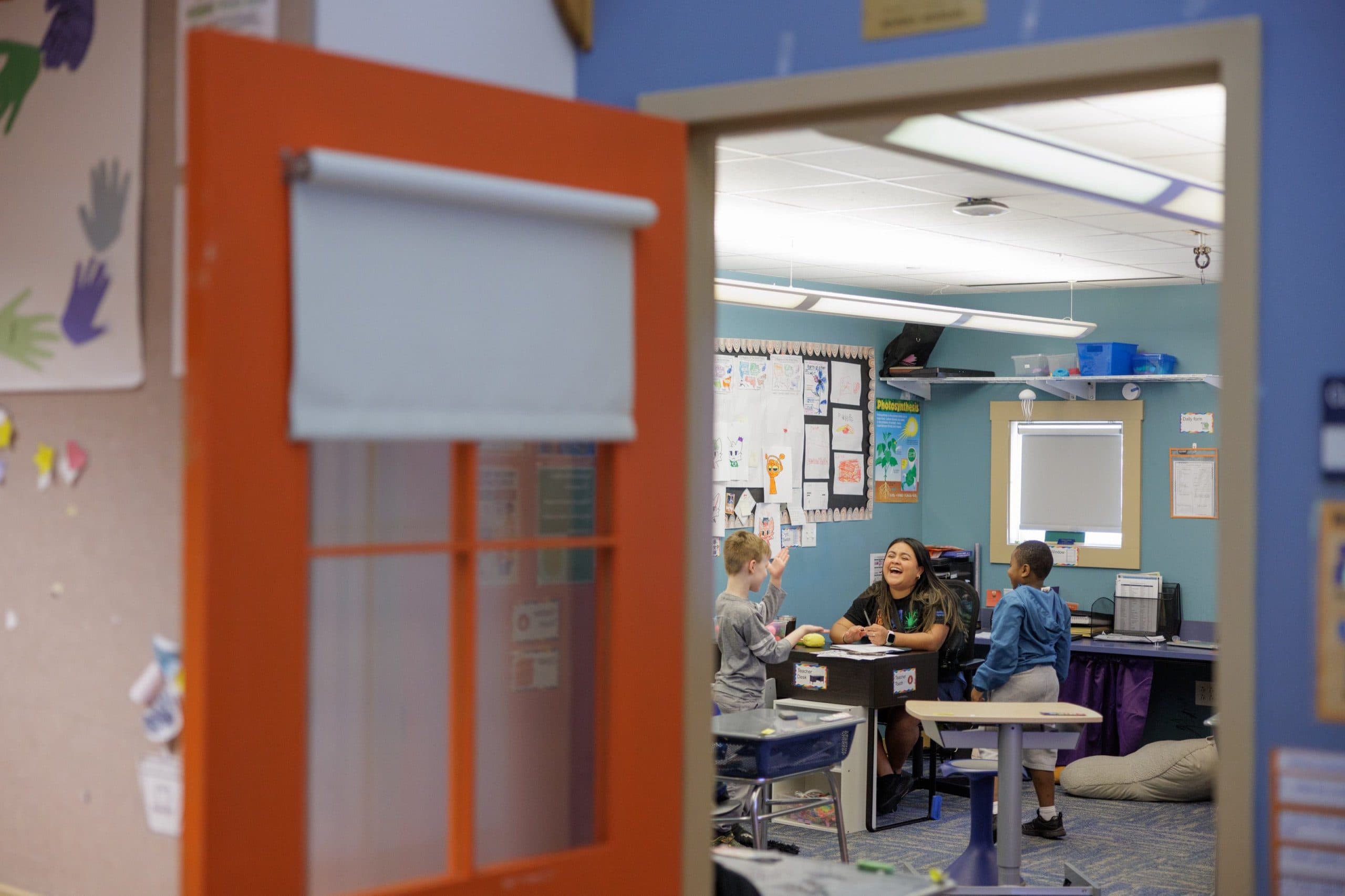 Teacher laughing with students