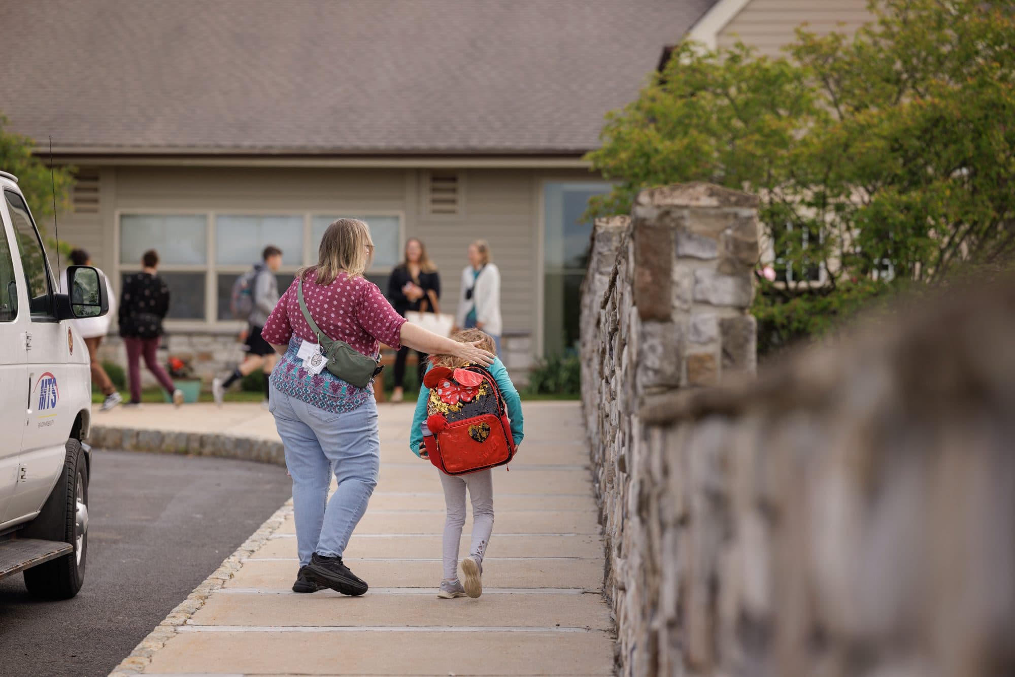 Parent walking with a young student