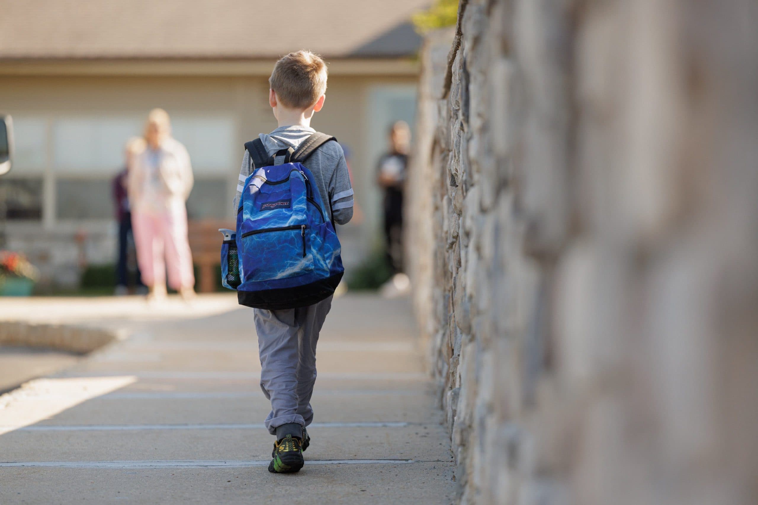 Student walking to school with a backpack
