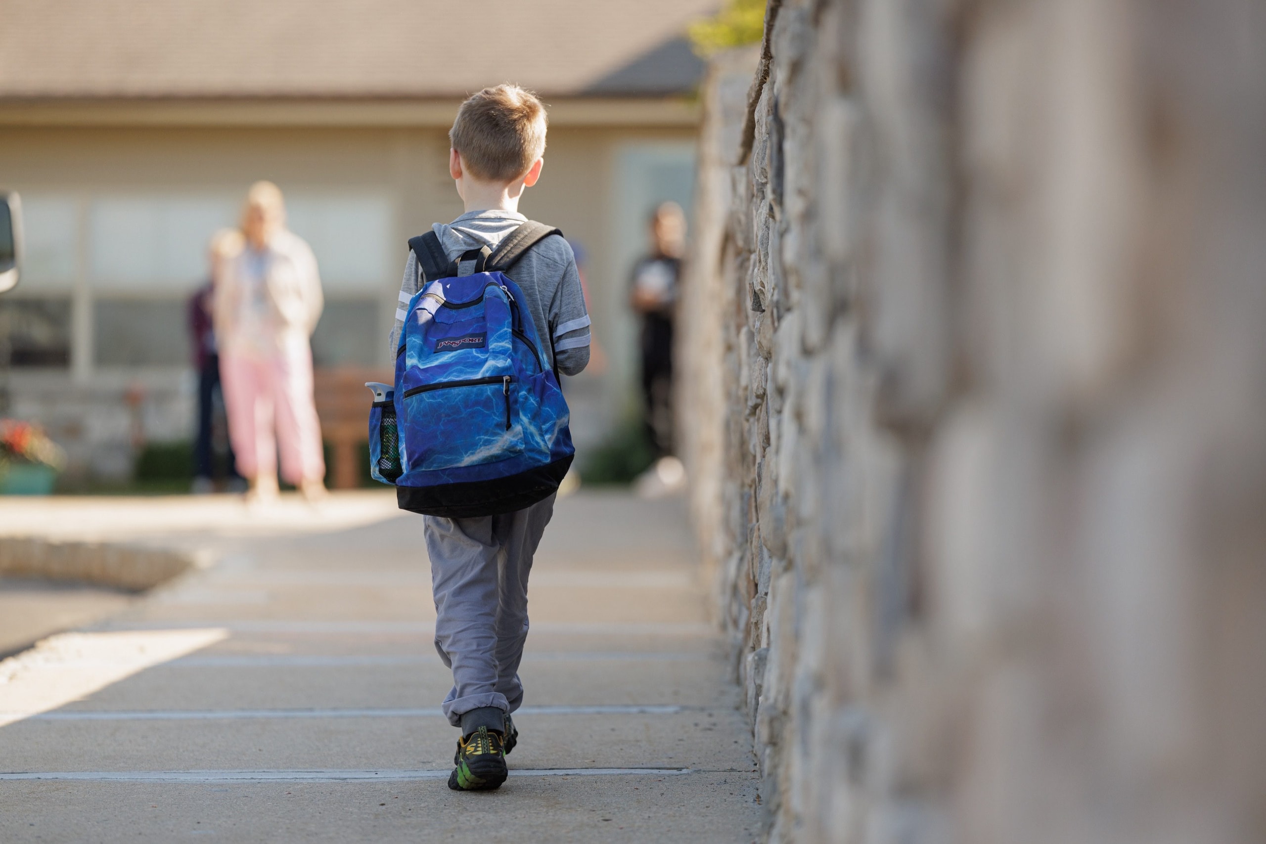 Student walking to school with a backpack