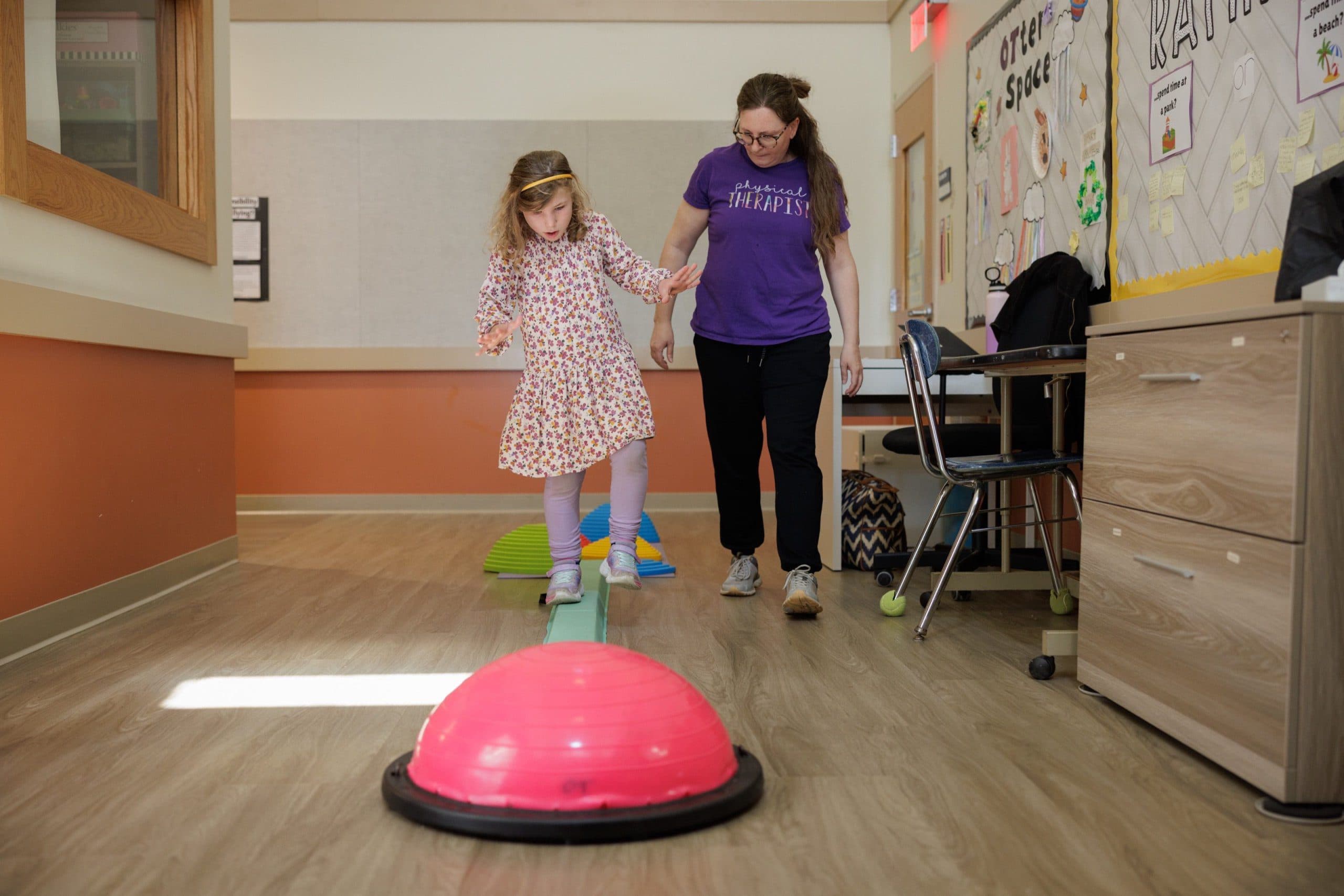 Student and staff member doing a balance exercise