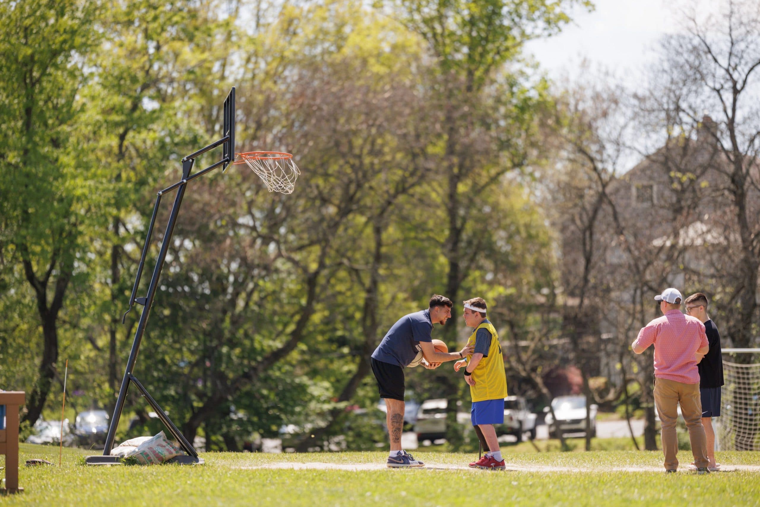 Student playing basketball outdoors