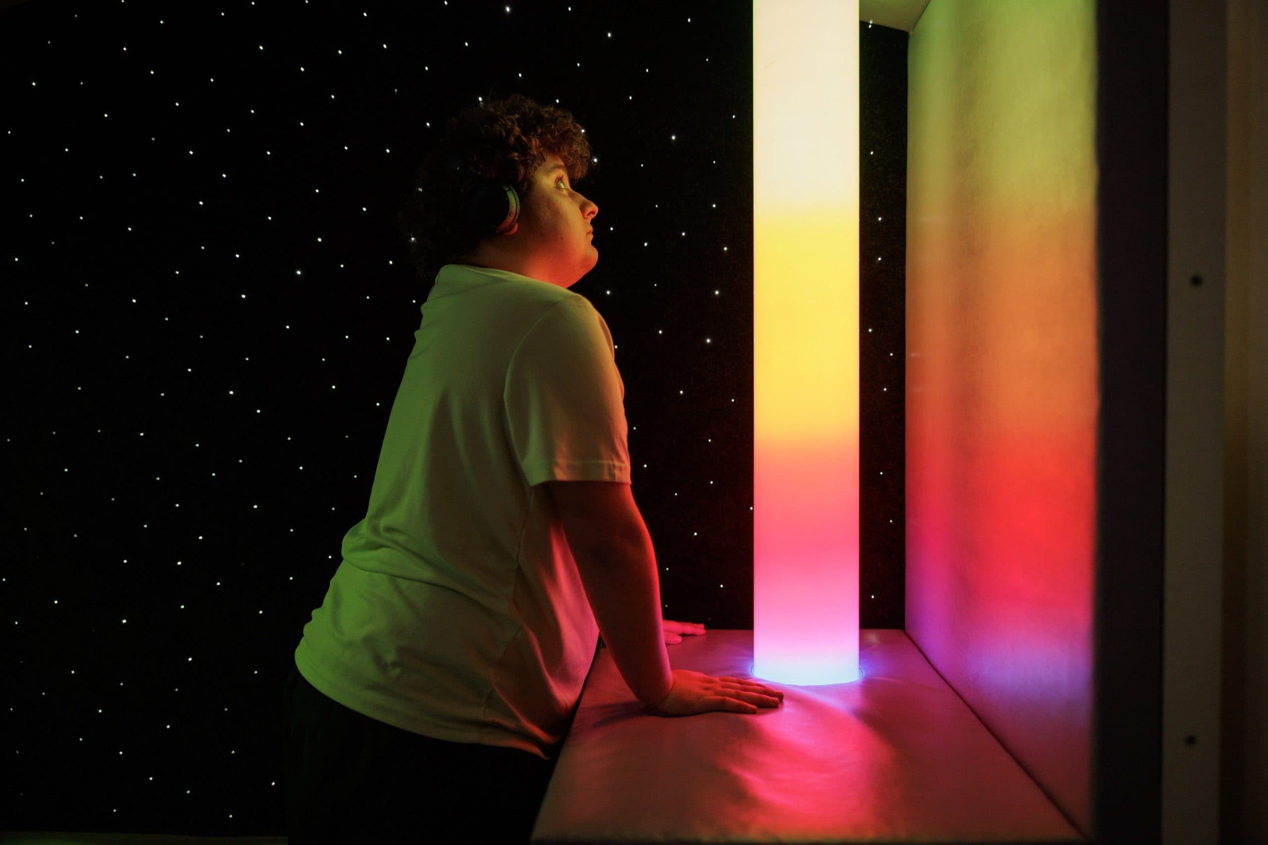 Student looking at the sensory lights in the sensory room.