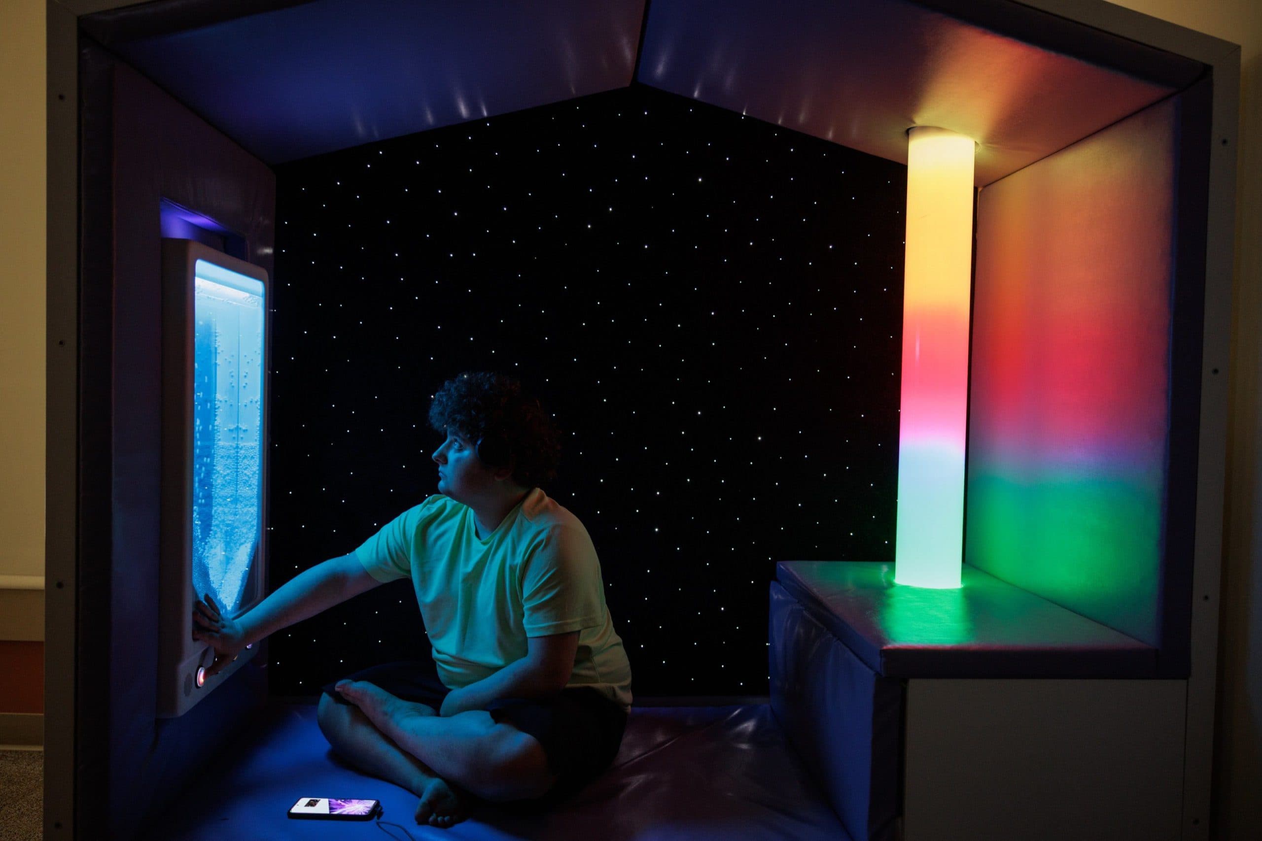 Student sitting in the sensory room.