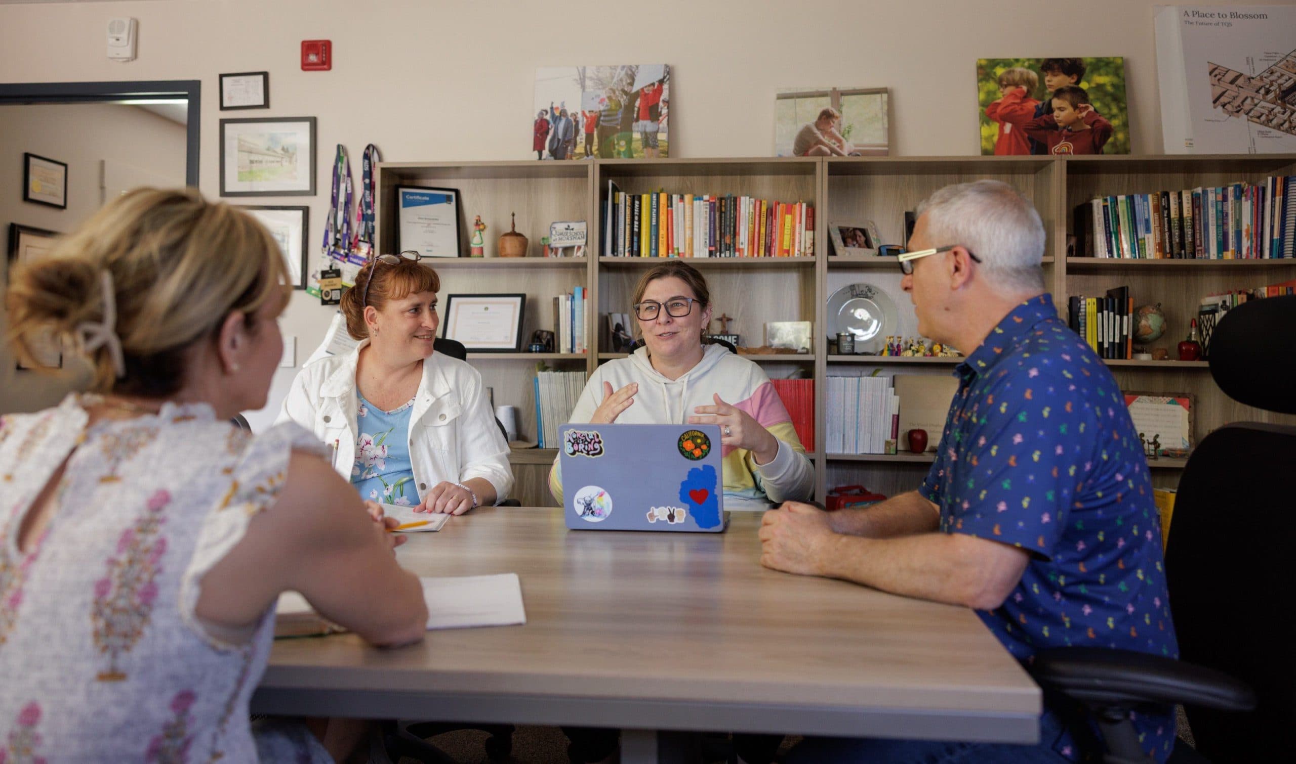 Staff members meeting around a table