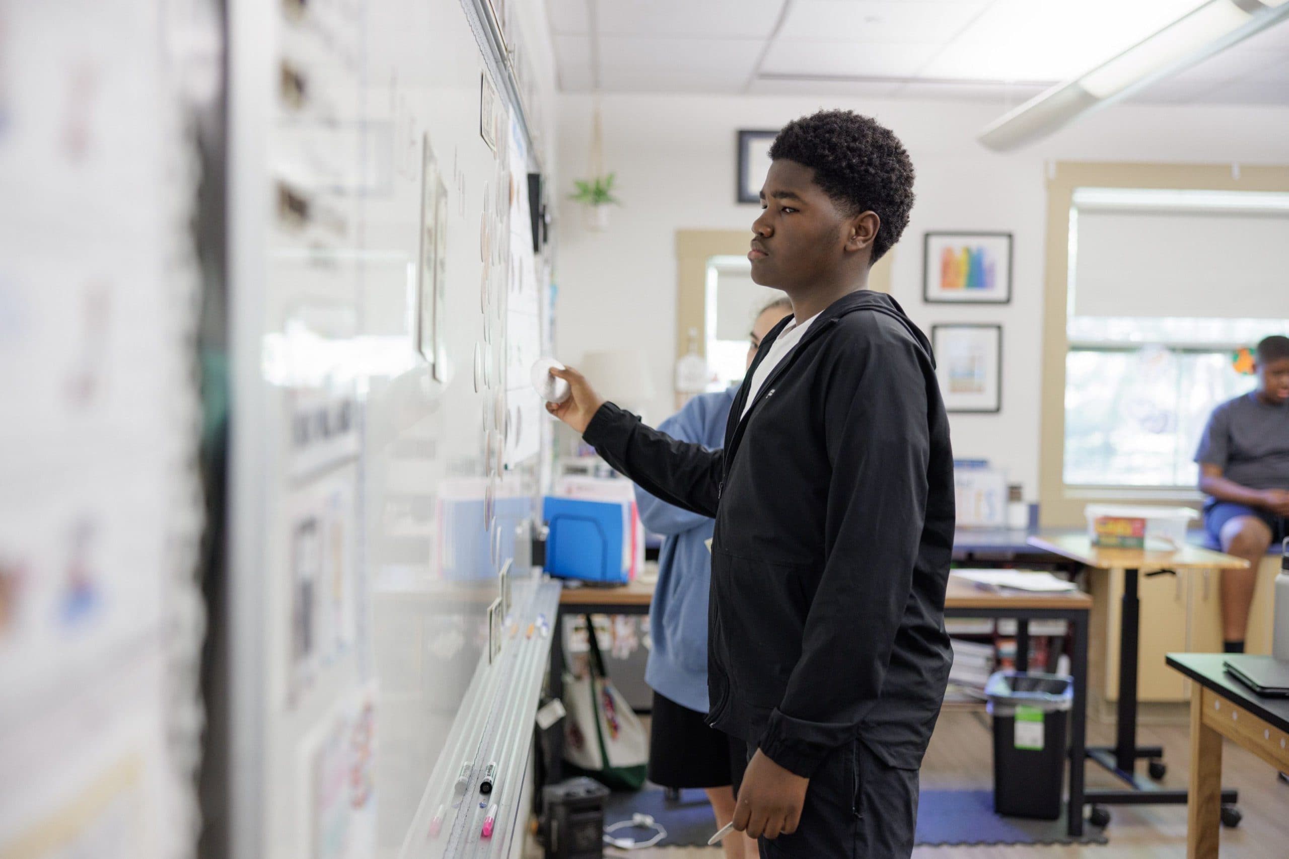 Student working at the classroom whiteboard