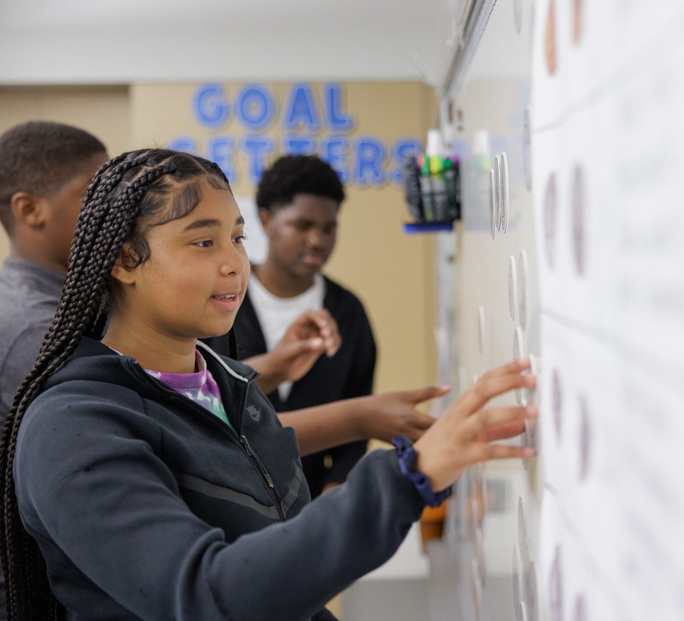 Student using the classroom whiteboard