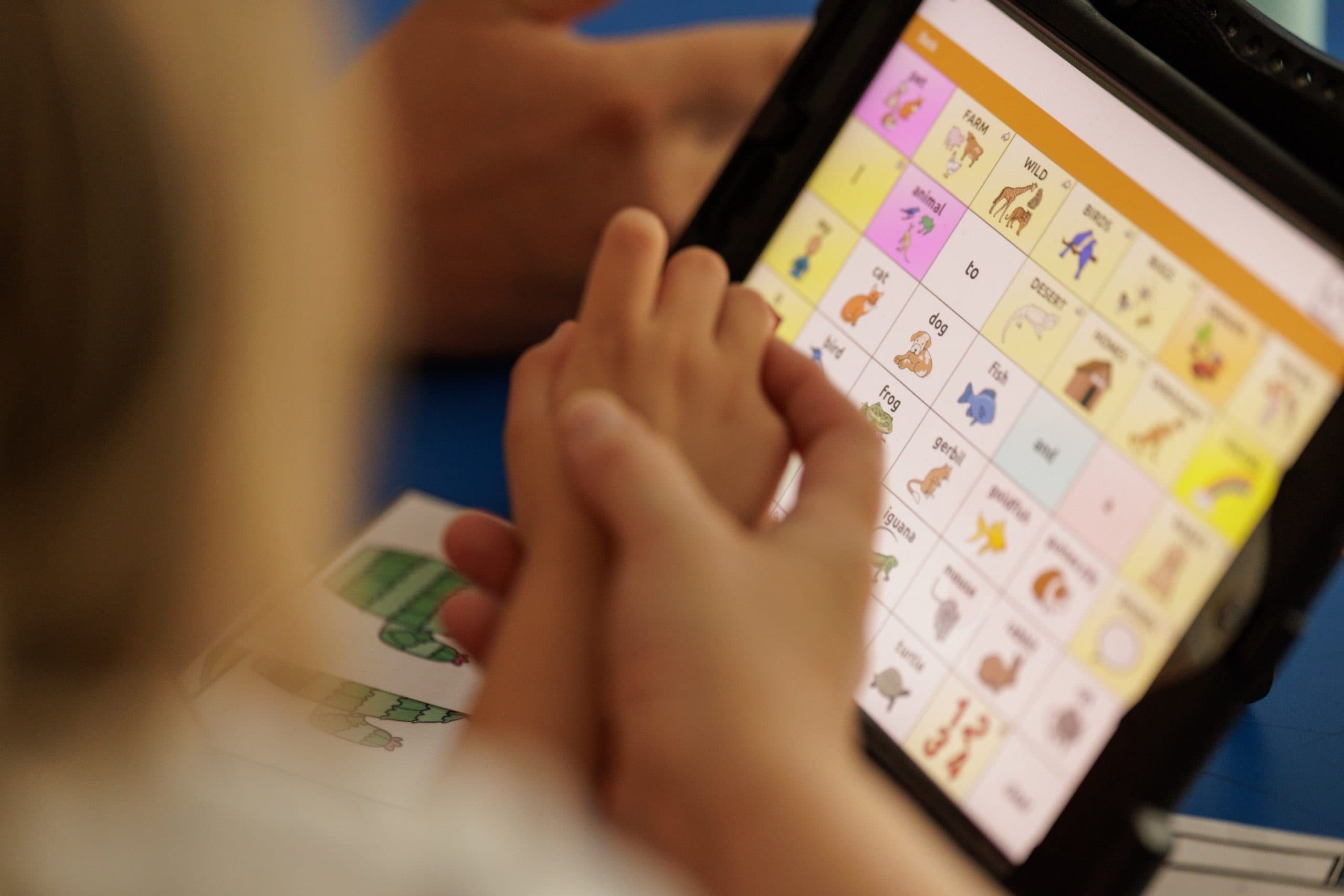 Student using an AAC communication tablet