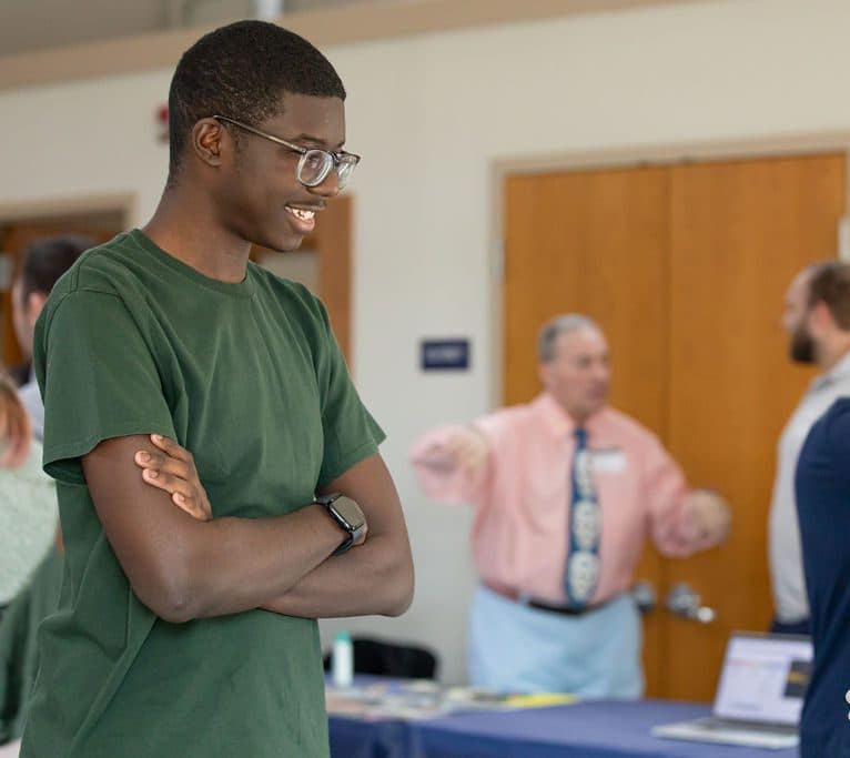 Smiling student during a group gathering