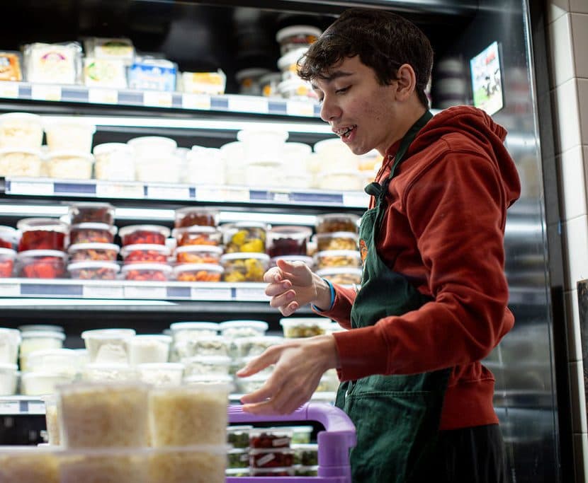 Student working in a grocery shop