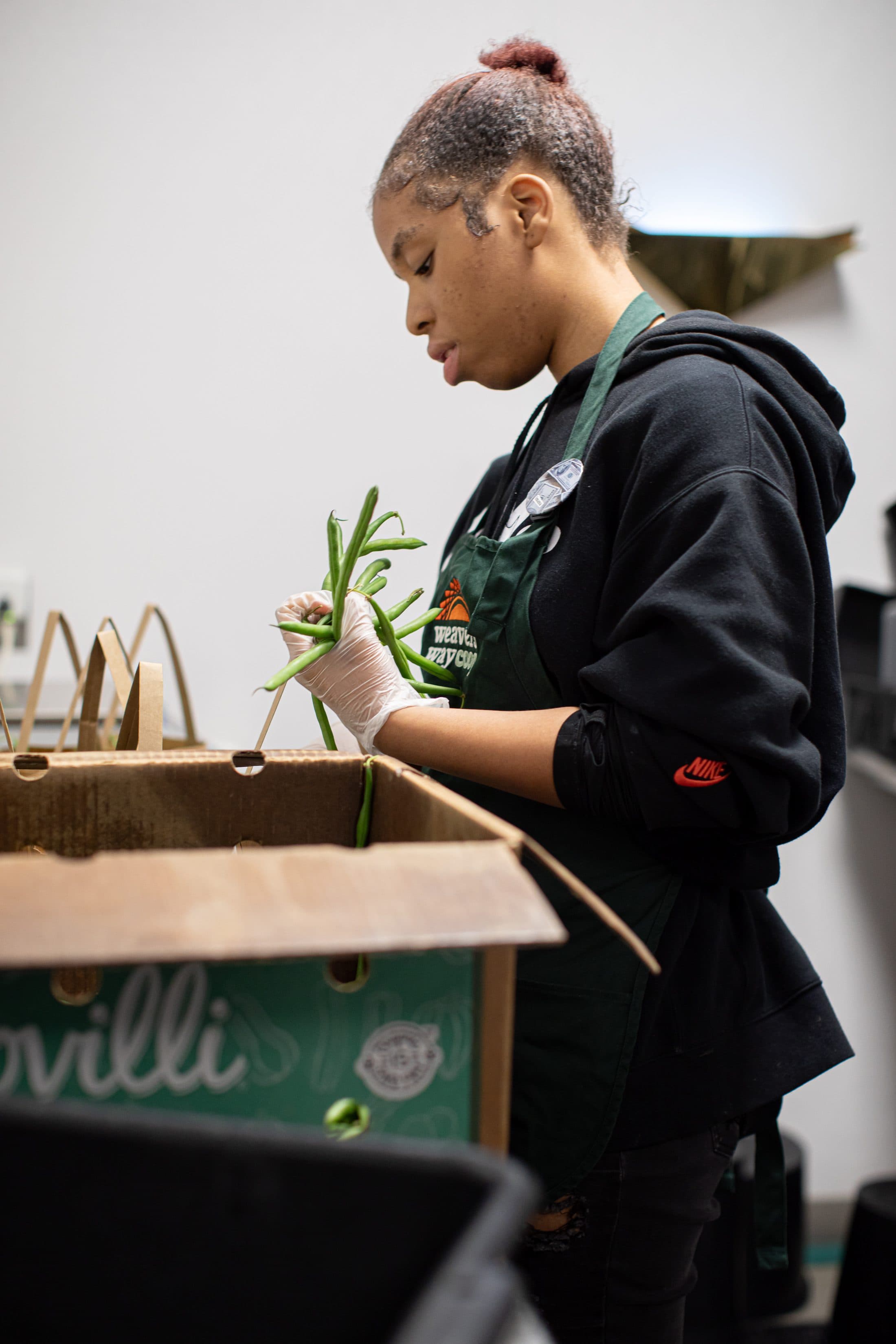 Student working with plants during a Weavers Way Co-op community placement