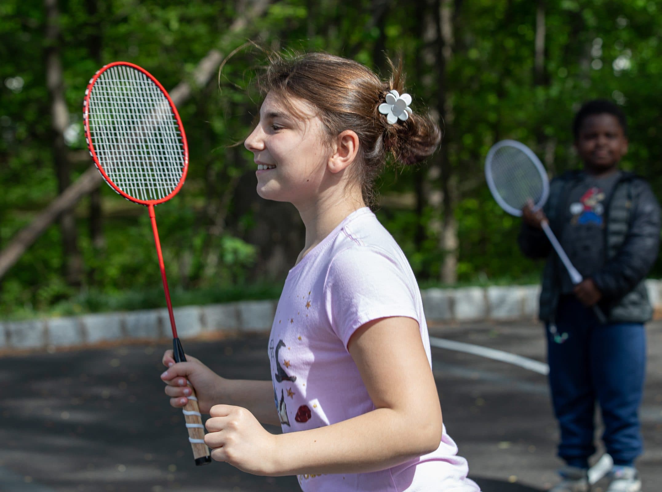 Student playing badminton outdoors
