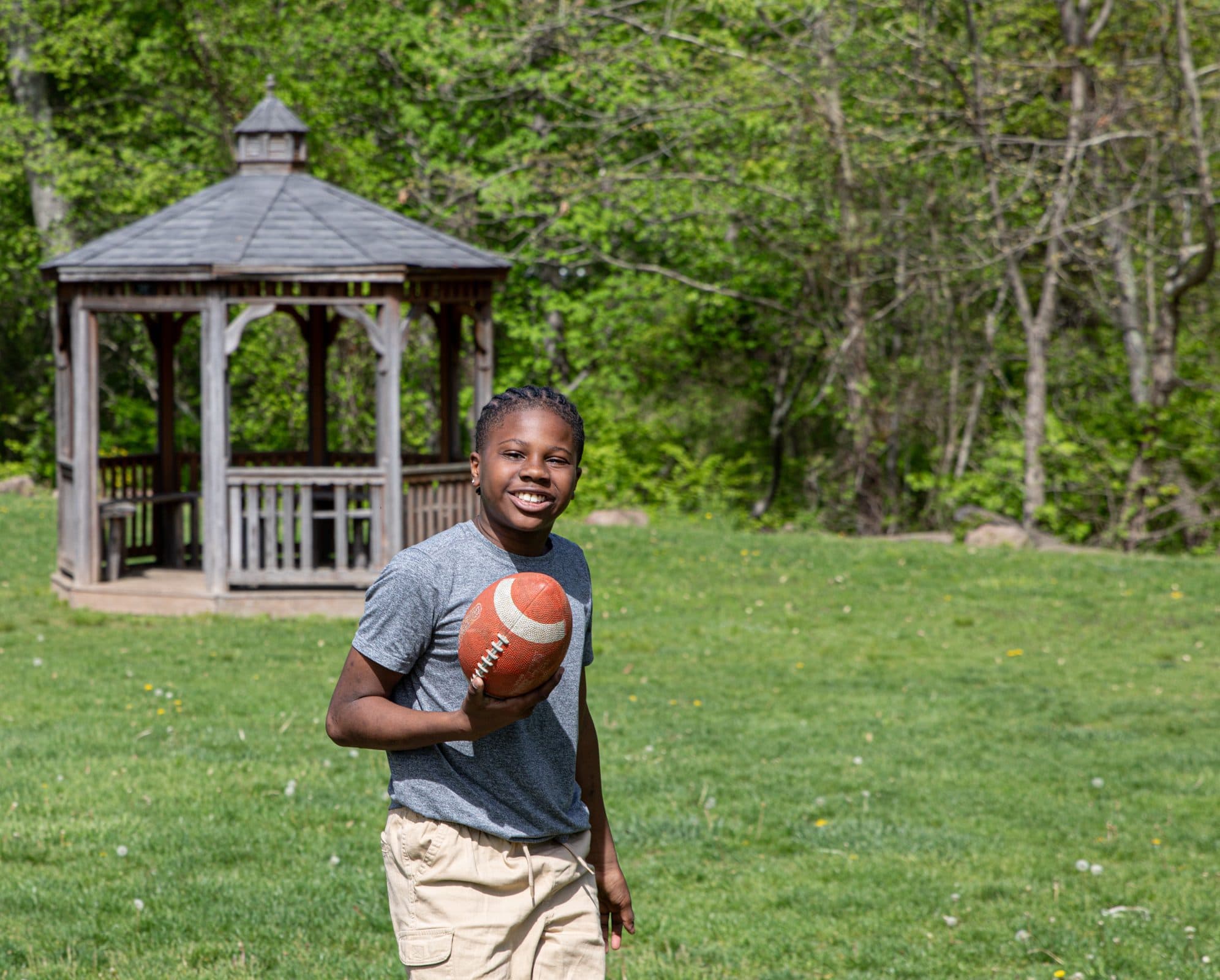 Student outdoors holding a ball