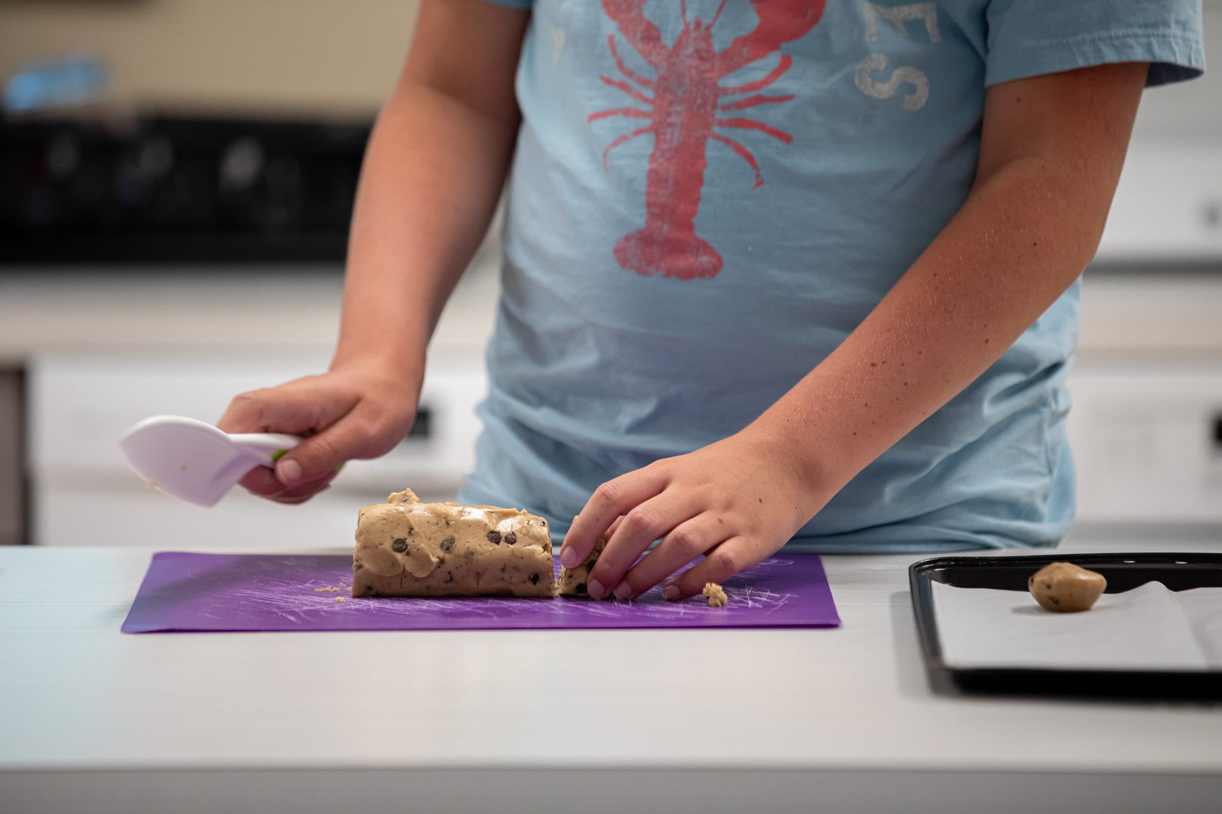 Student cutting food during a cooking activity