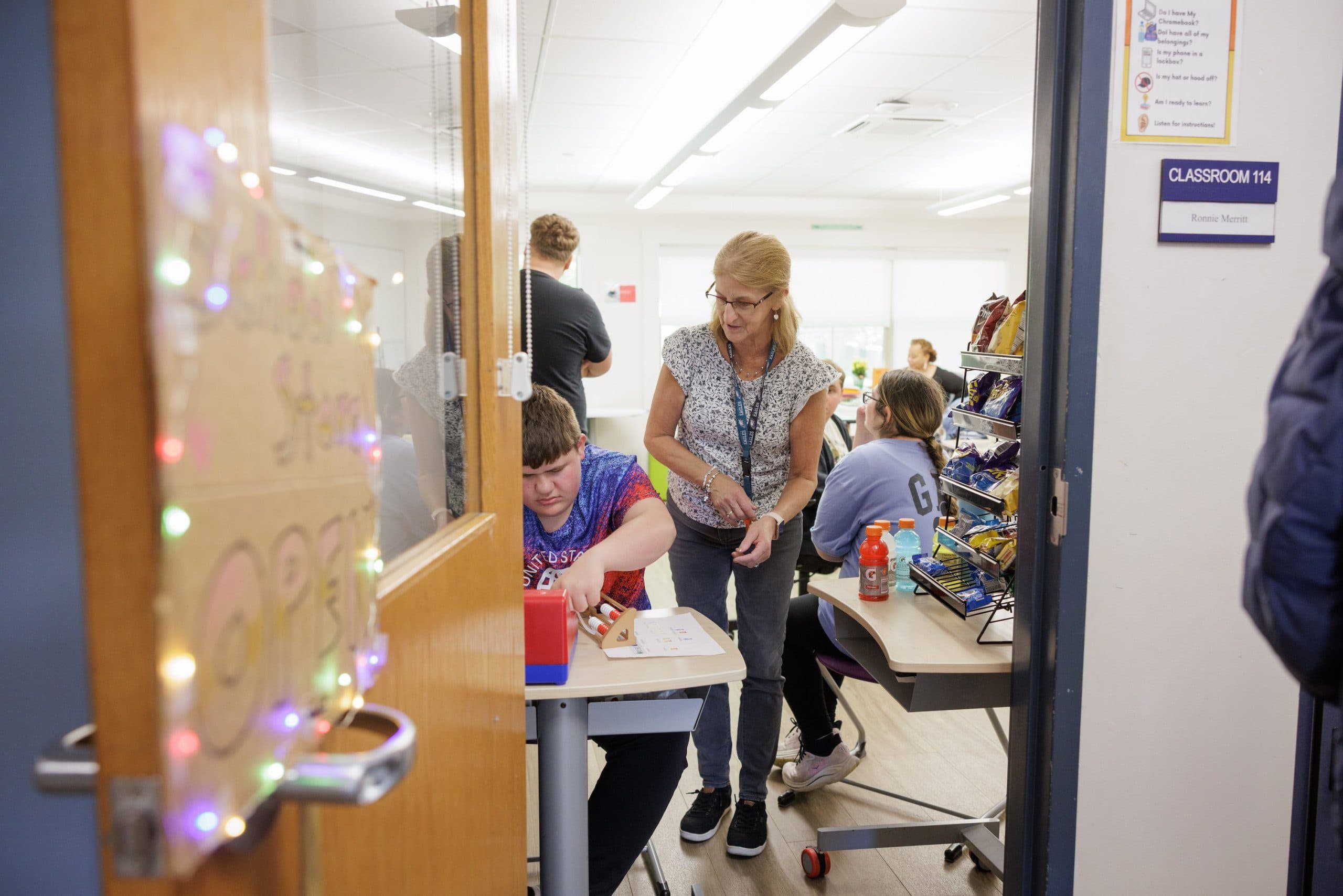 Teacher and students in a decorated classroom
