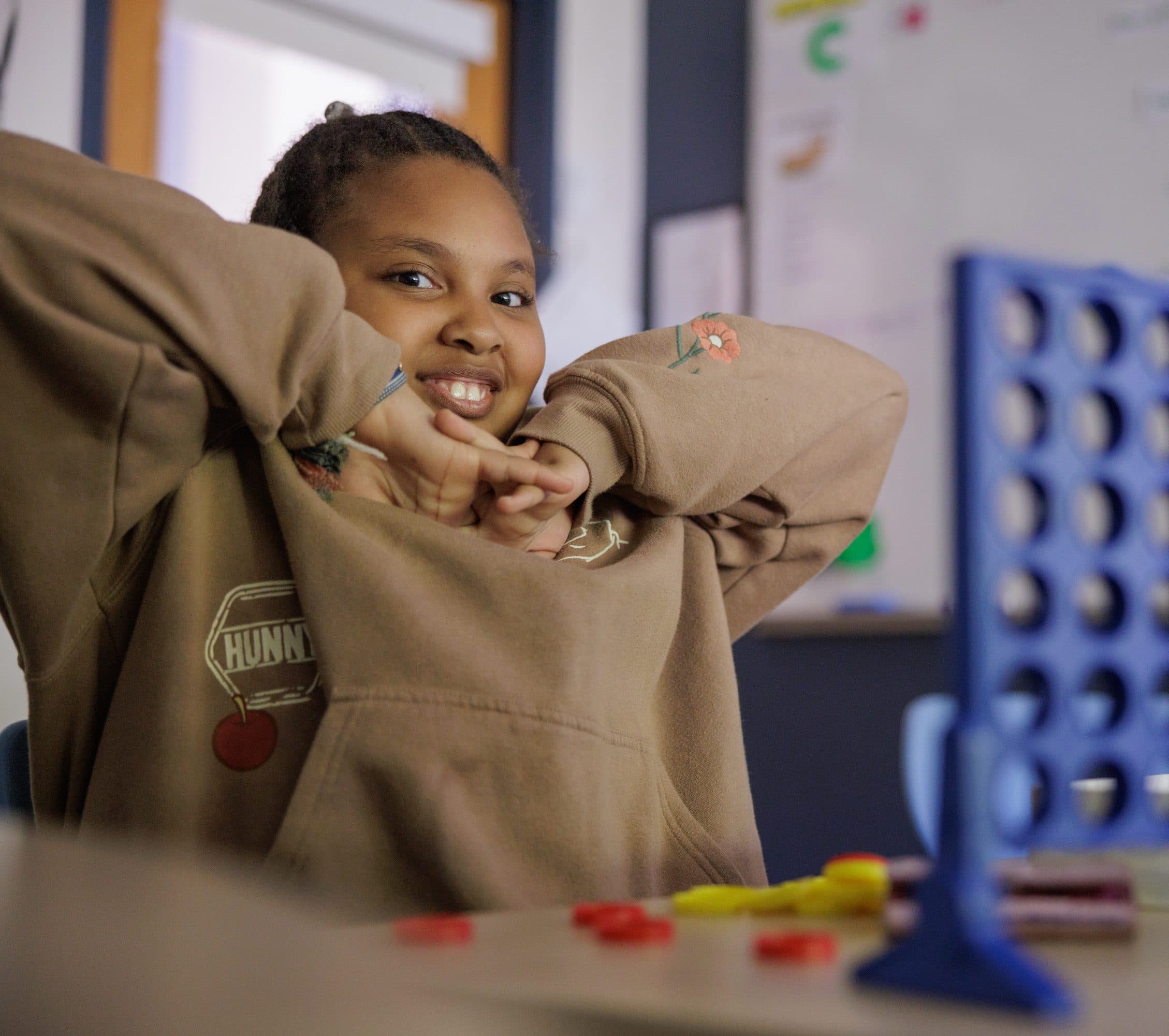Student smiling during a classroom activity