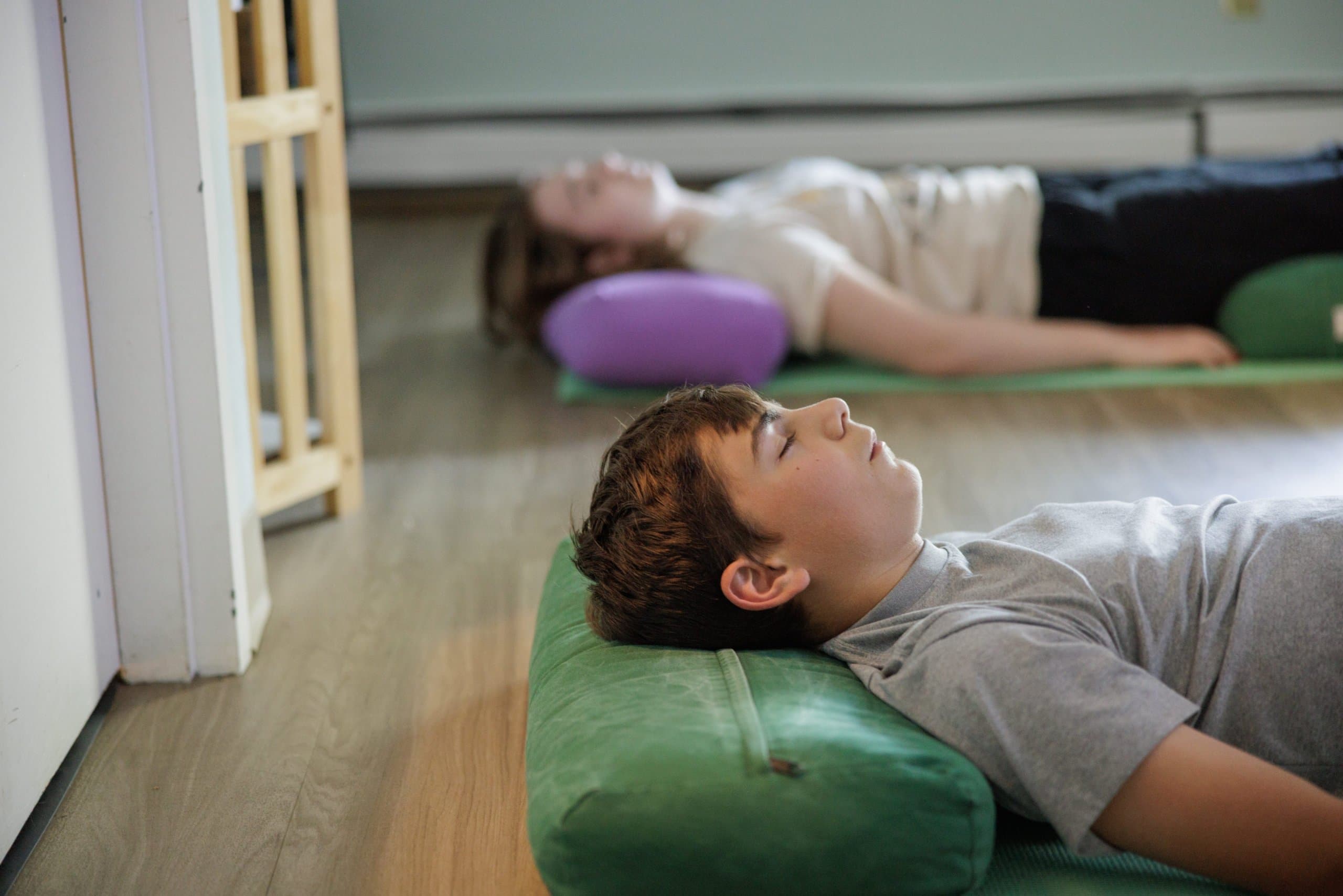 Students relaxing on mats during a mindfulness activity