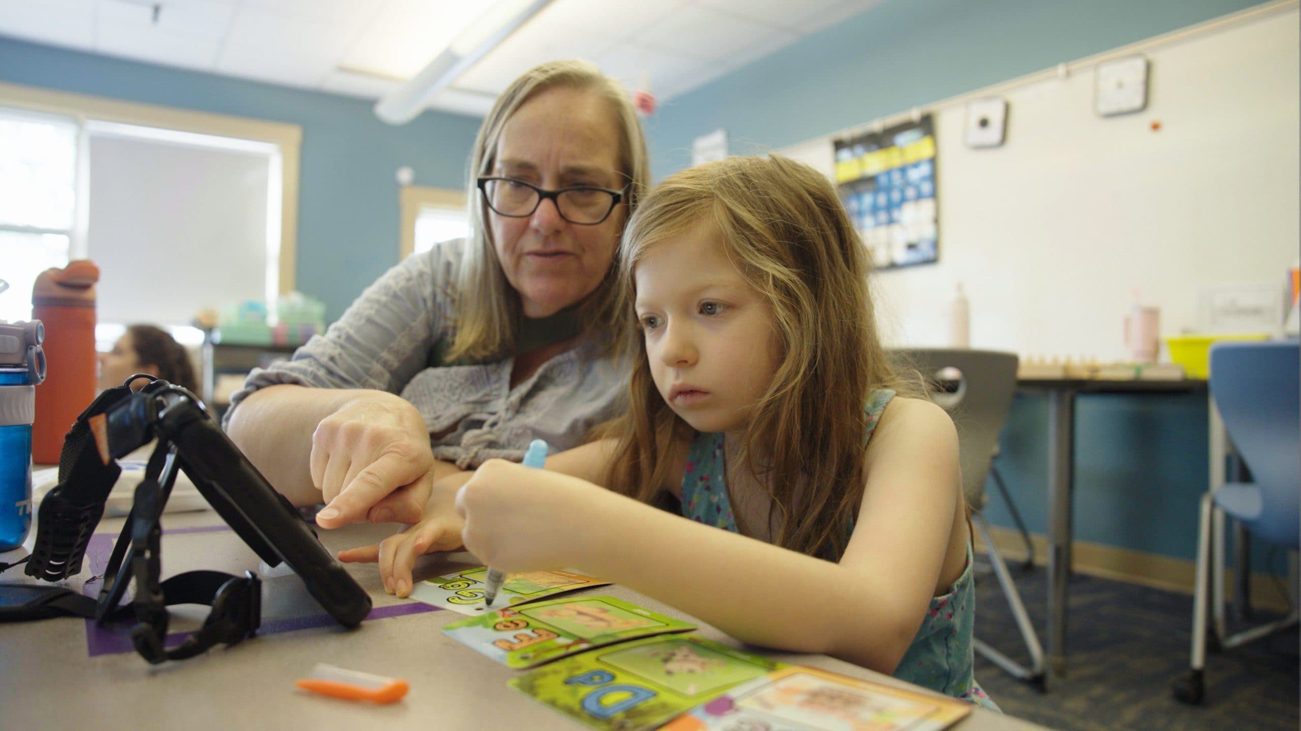 Student and teacher working together in a classroom
