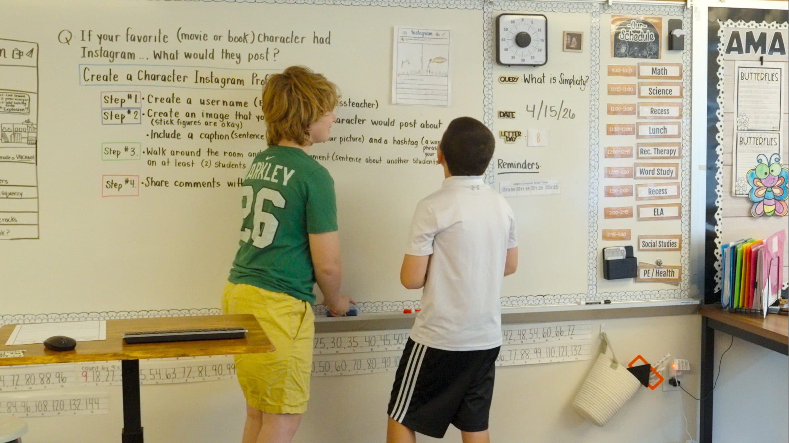 Students writing on a classroom whiteboard