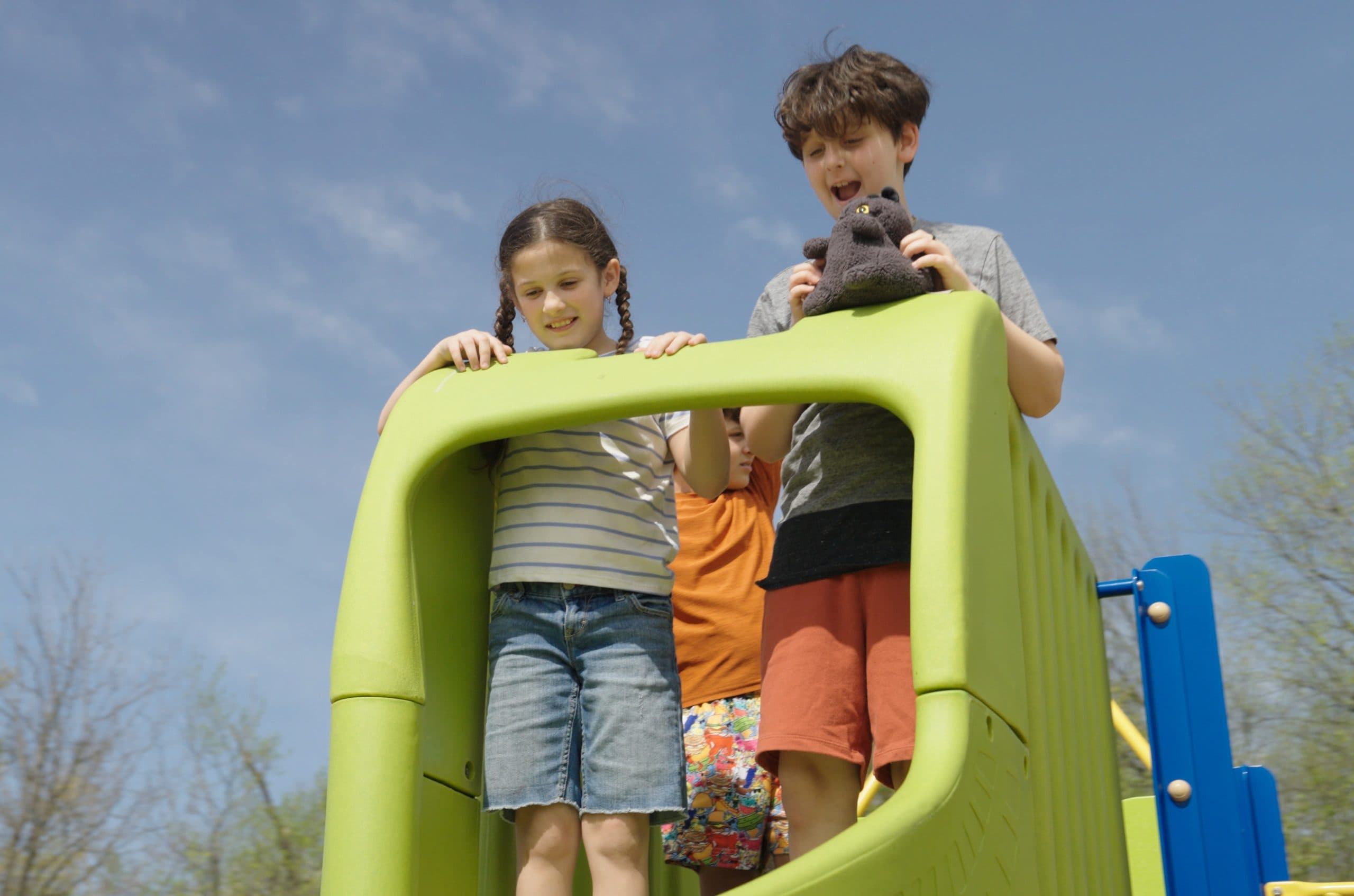 Students playing on outdoor play structure