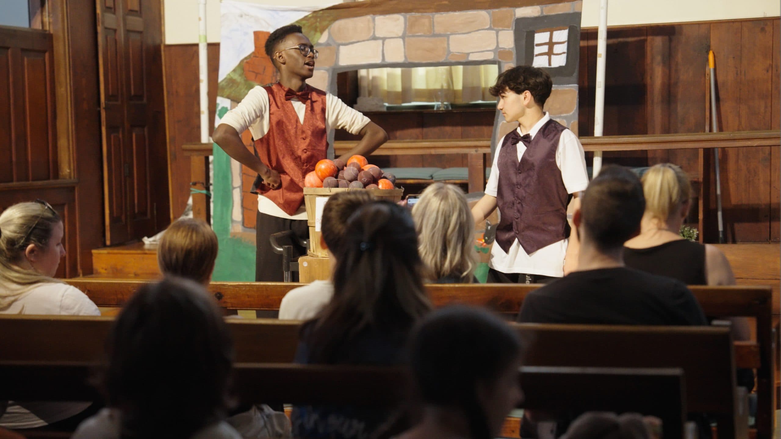 Students performing in costume during a drama activity