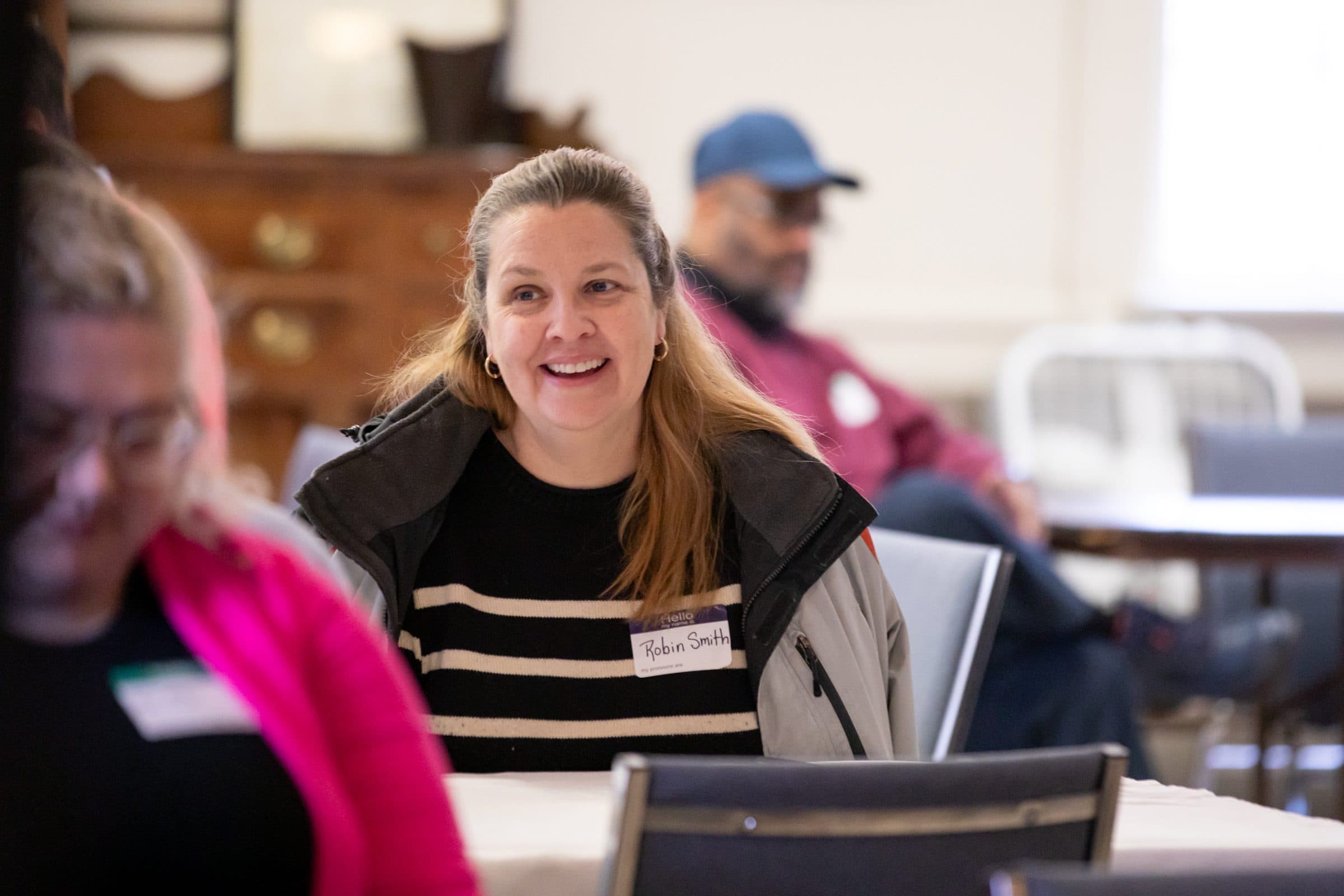 Volunteer smiling during a group gathering