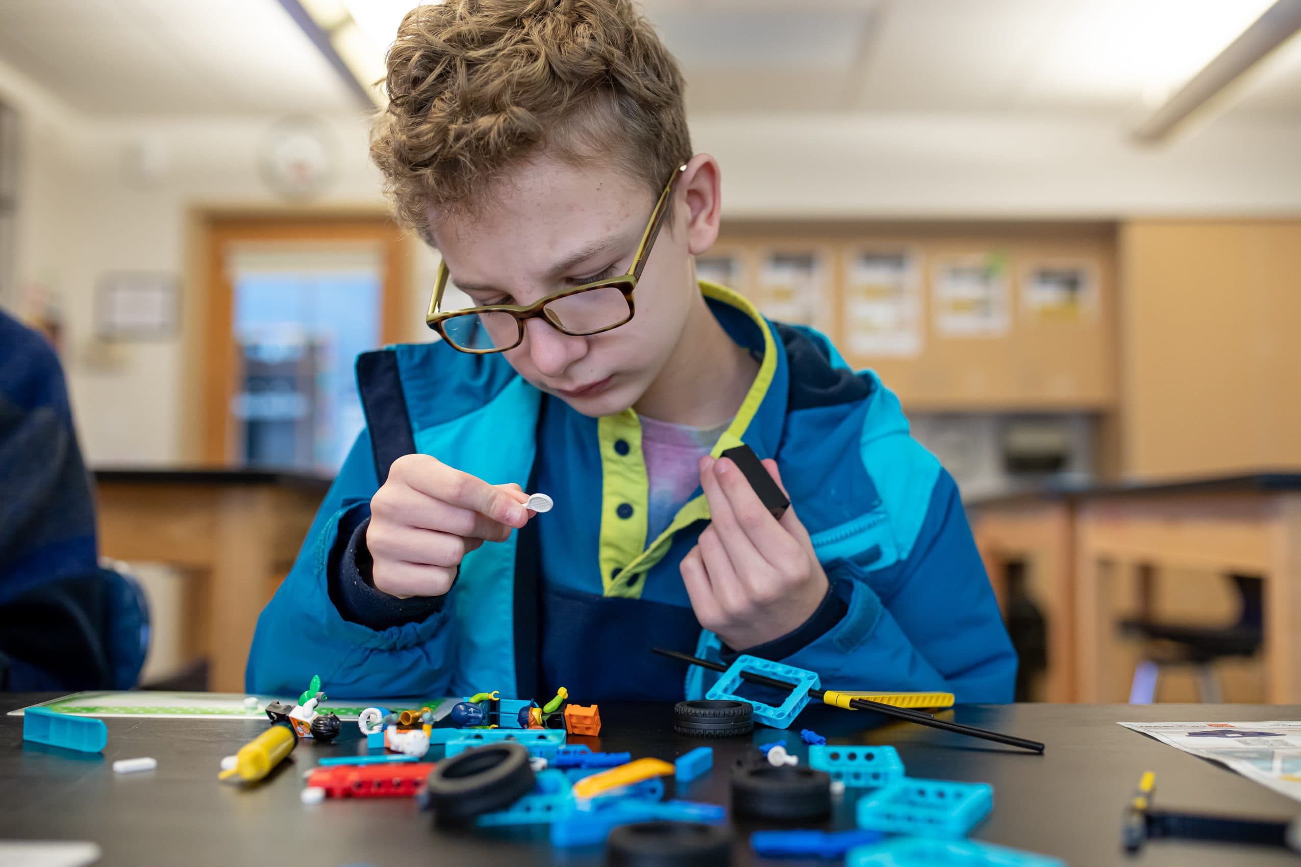 Student playing with lego in a classroom