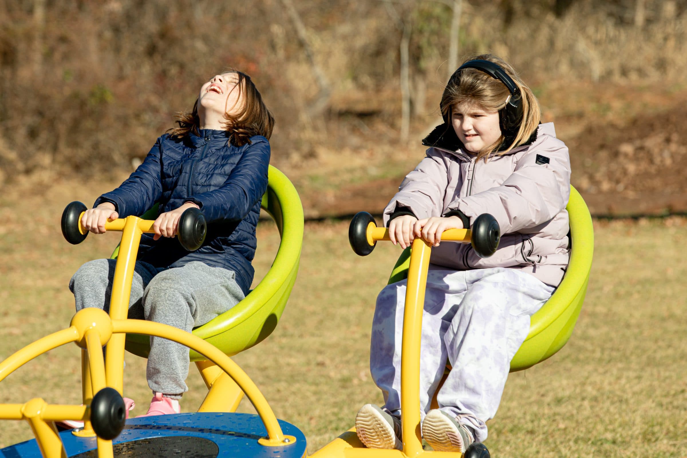 Students using playground swings