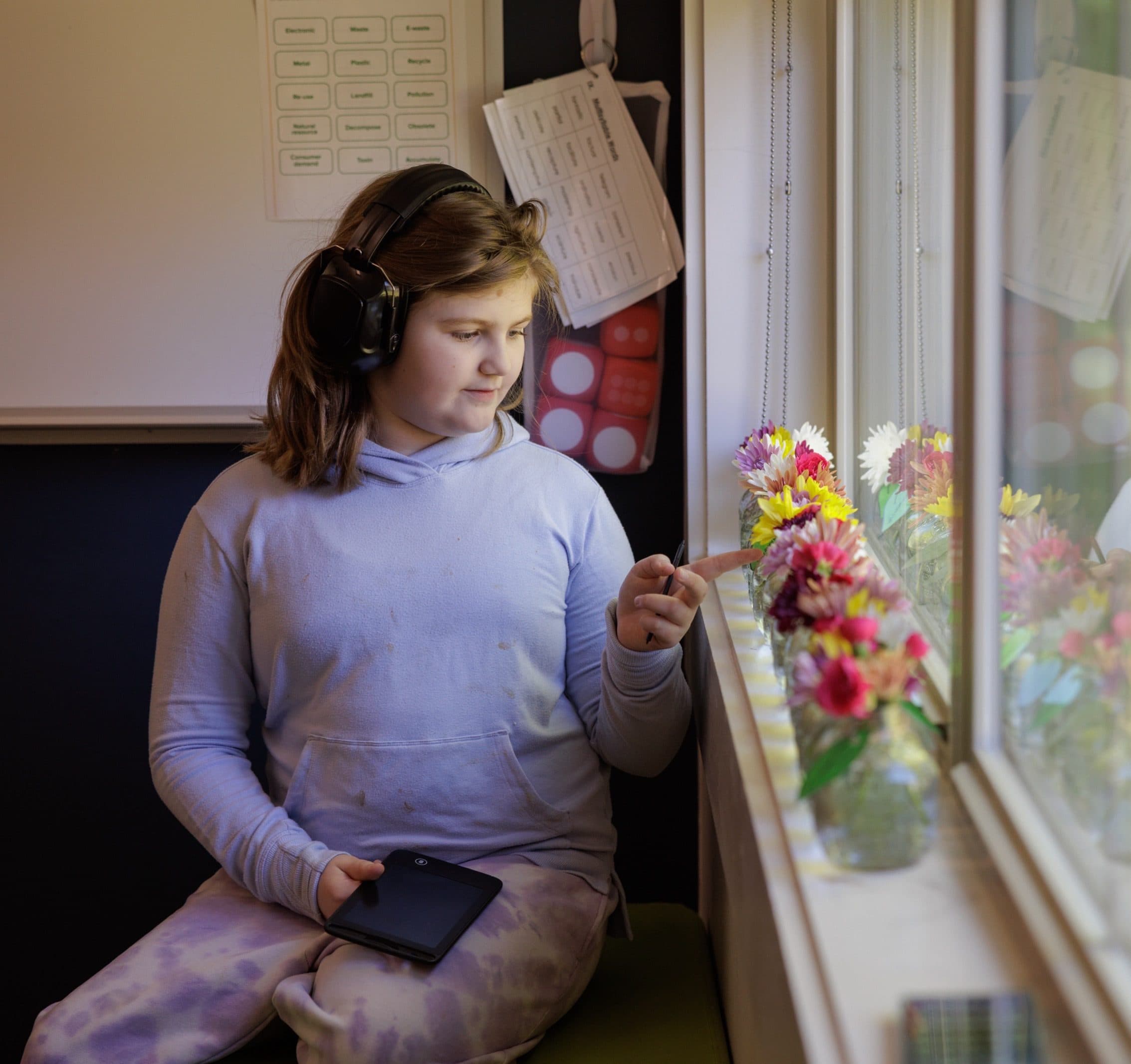 Student standing near a decorated window